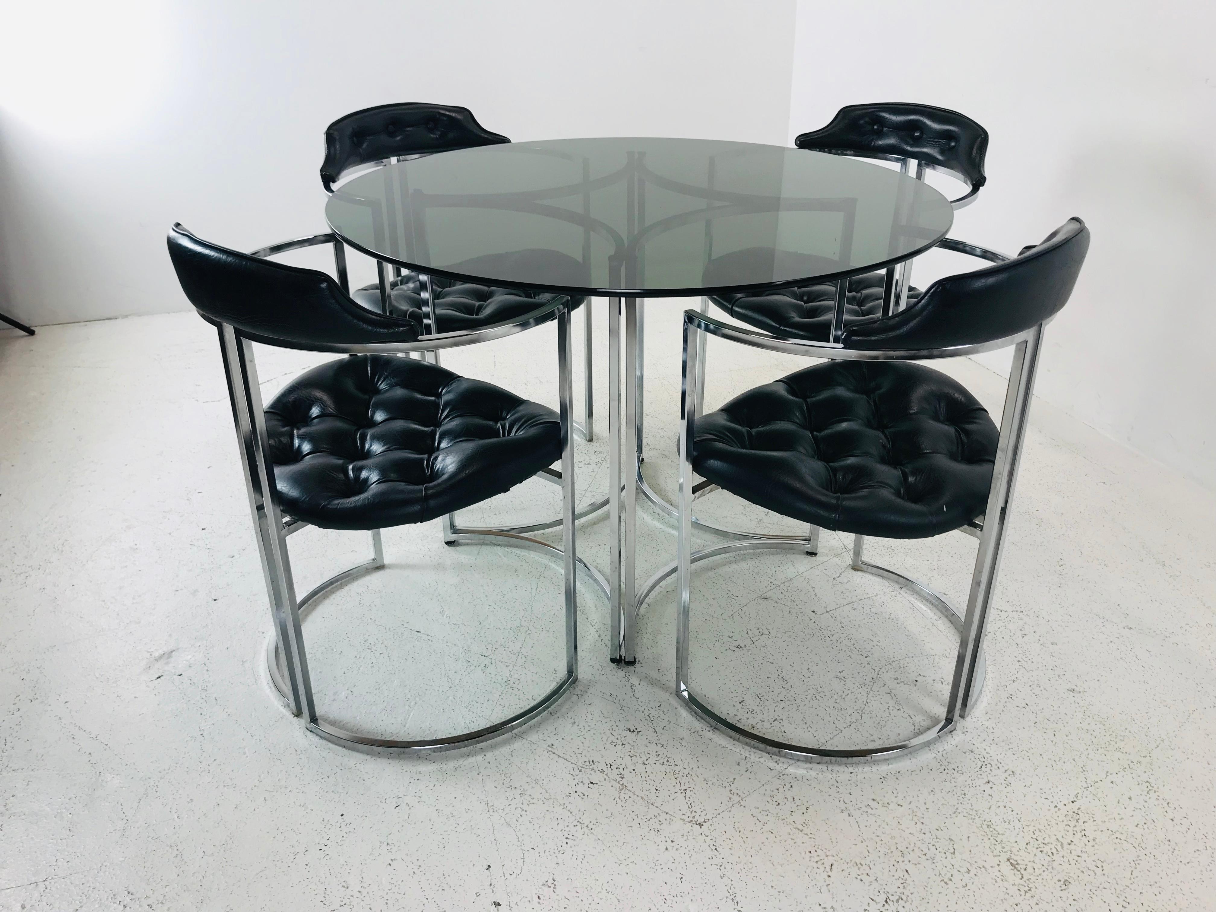 Four Daystrom chairs with smoked glass table top with chrome base.
Table is 42 D x 29 H
Chairs are 22 W x 27 D x 37 H SH 20