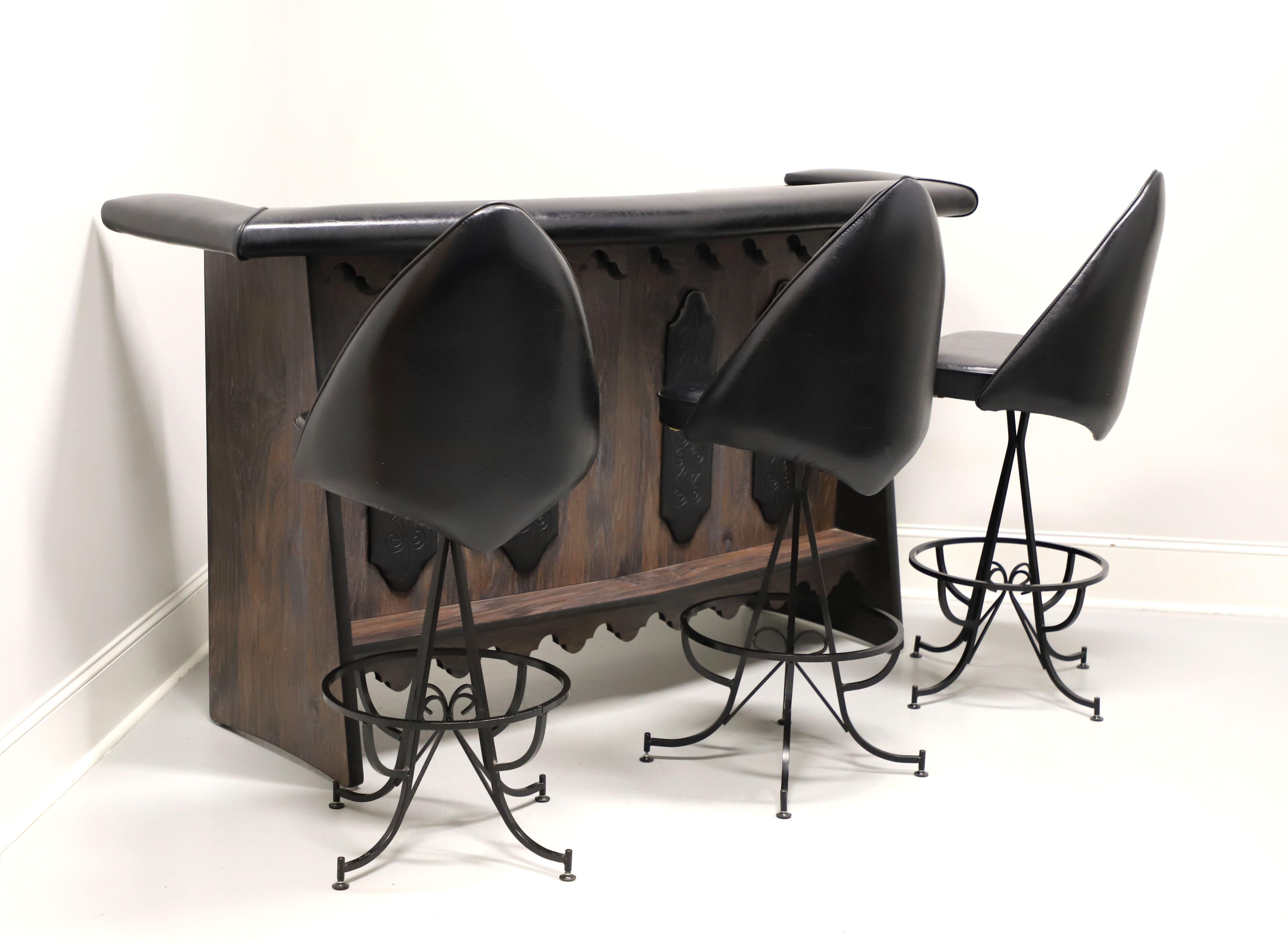 A bar set, bar and three barstools, in the Gothic style by Daystrom Furniture. Bar is solid wood with four decoratively carved black painted placards to front, angled side panels, wood foot rail on the front side, and carved apron under foot rail.