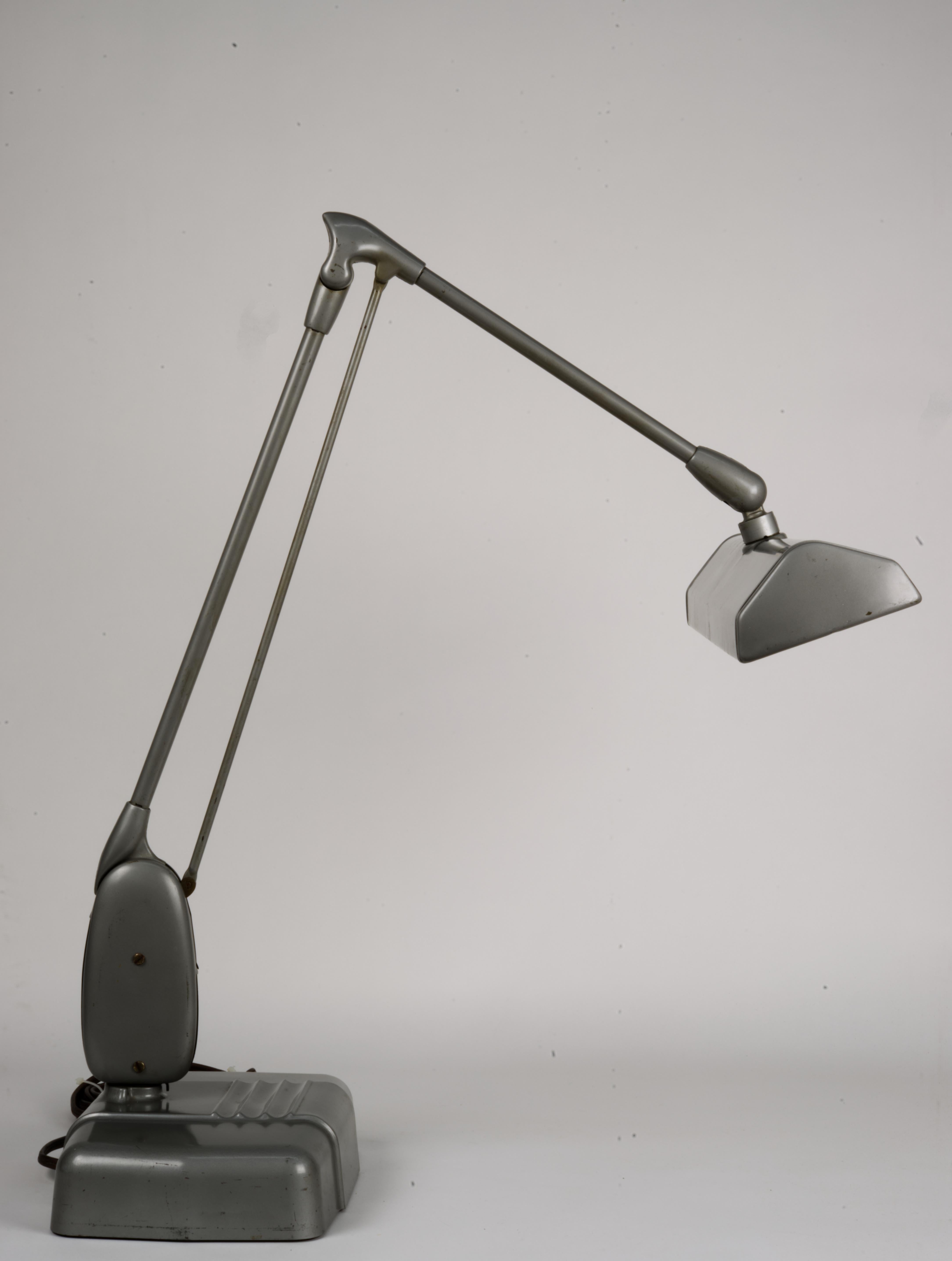 This is a famous floating arm lamp by Dazor. Company was founded in 1938 and made itself the name on this design for it's durability, ease of adjustment and most importantly, for strong an even light quality. Lamp was often used by the diamond