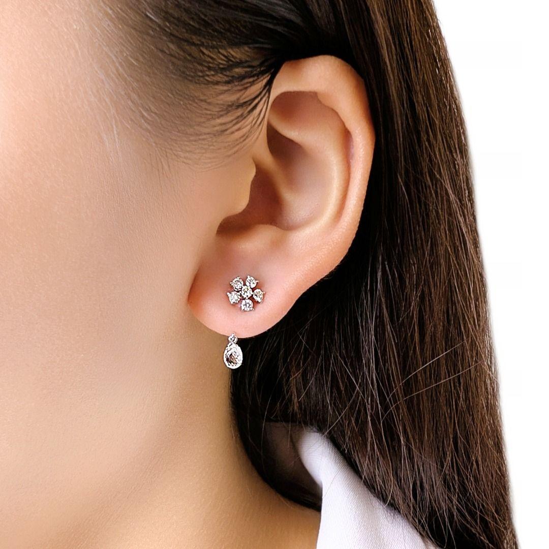 Ces élégantes boucles d'oreilles gouttes présentent 2 diamants taille rose (0,4 ct au total) de couleur douce G et de pureté VS, associés à 12 diamants ronds de taille brillant (0,30 ct), de couleur G-H et de pureté VS. Serties dans de l'or blanc