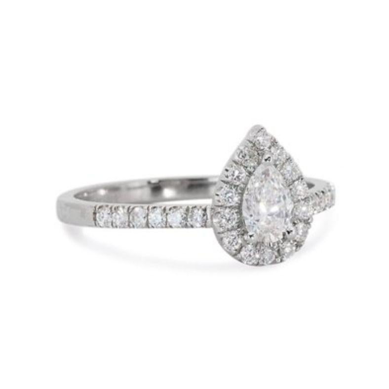 Embrace captivating elegance with this exquisite ring, showcasing a mesmerizing 0.7-carat pear brilliant diamond. This breathtaking centerpiece, boasting the coveted D color (colorless) and VVS1 clarity (very, very slightly included), radiates