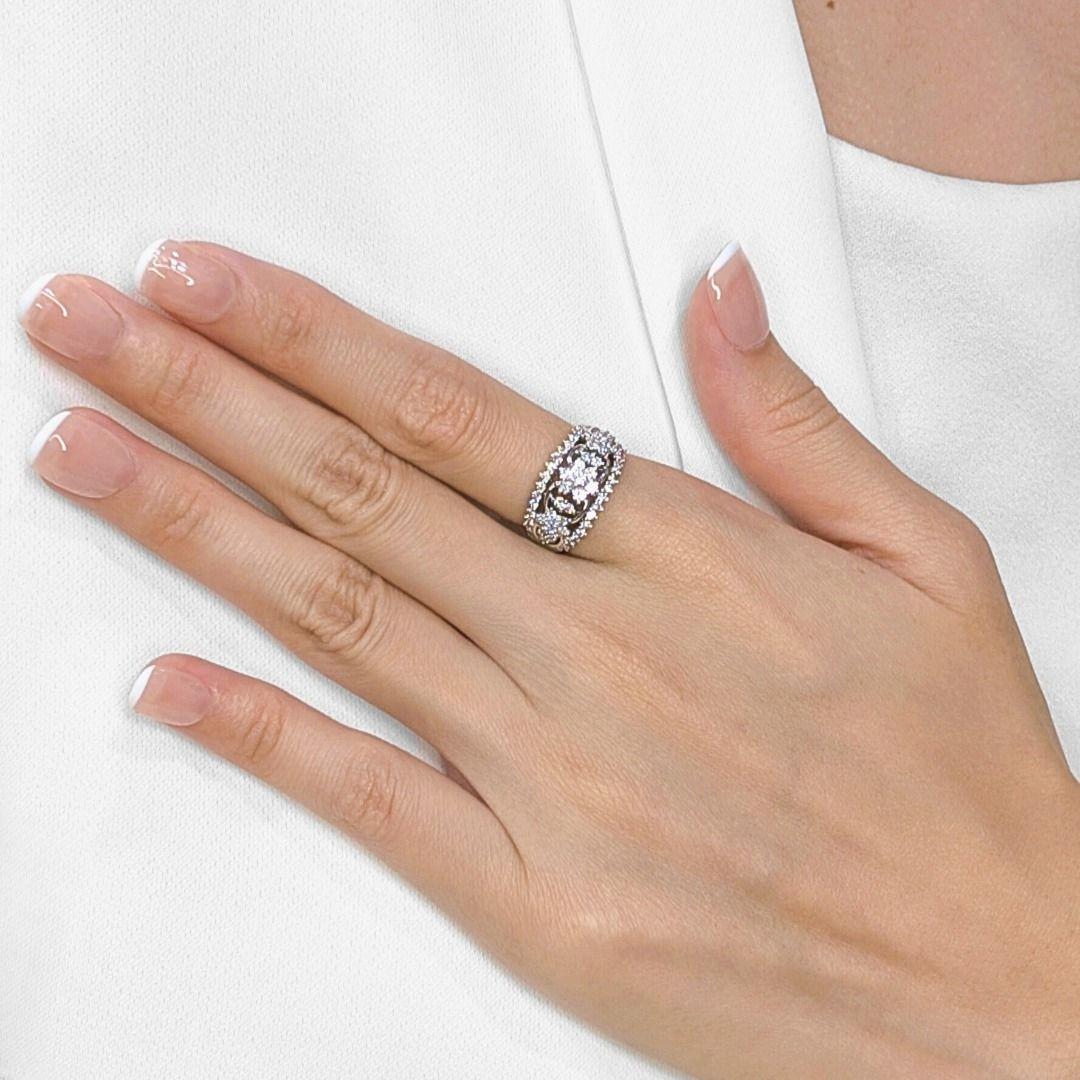 Discover unparalleled artistry with this very detailed and styled ring, meticulously crafted in radiant 18K white gold. A dazzling array of fifty-five natural round brilliant diamonds, totaling a brilliant 0.84ct, creates an exquisite tapestry of