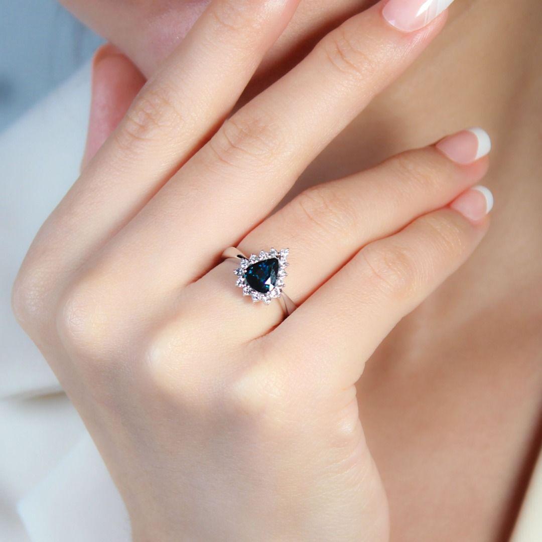 This ring is more than just jewelry; it's a conversation starter. The unique blue-green sapphire paired with sparkling diamonds creates a mesmerizing visual dance. Its delicate design and comfortable weight make it perfect for everyday wear or