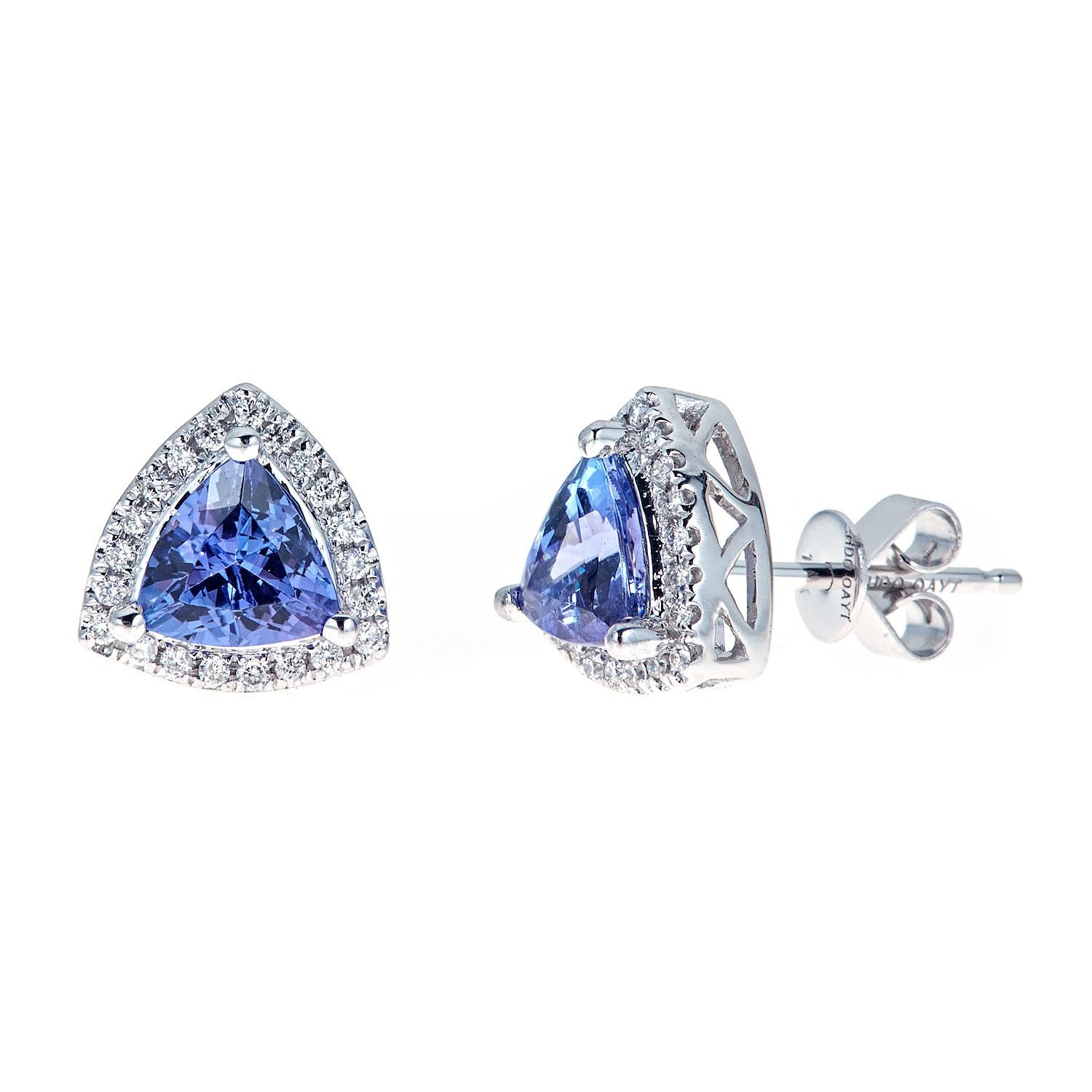 Elevate your elegance with these stunning 10K white gold earrings, showcasing exquisite trillion cut tanzanite stones, each weighing 1.5ct. Adorned with a brilliant halo of 27 sparkling diamonds on each side, these earrings create a mesmerizing