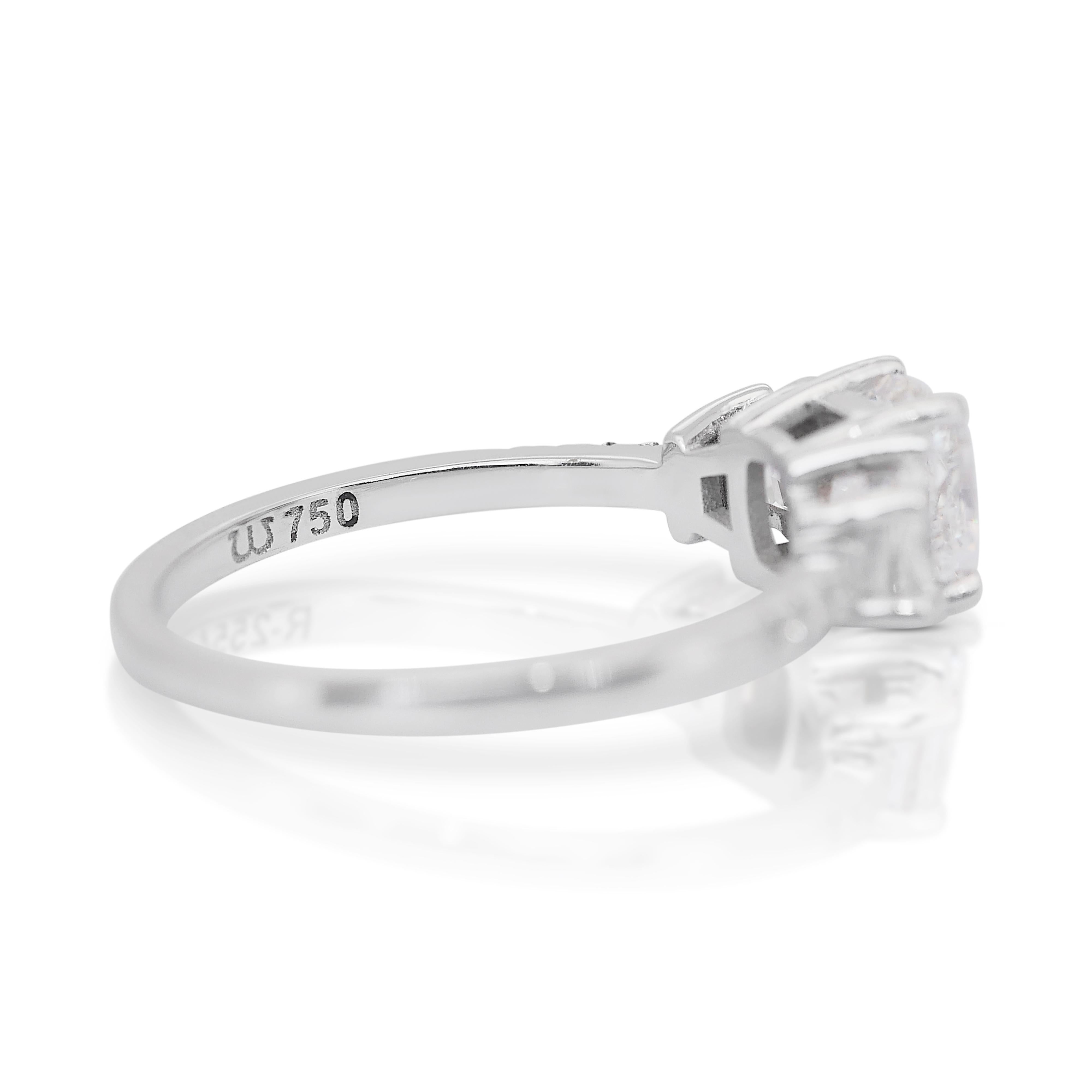 Dazzling 1.30ct Diamonds Ring in 18k White Gold - IGI Certified

This elegant 18k white gold ring features a breathtaking 1.00ct cushion-cut diamond at its center. Framing the centerpiece, two trapezoid-cut diamonds with 0.25ct total add a unique