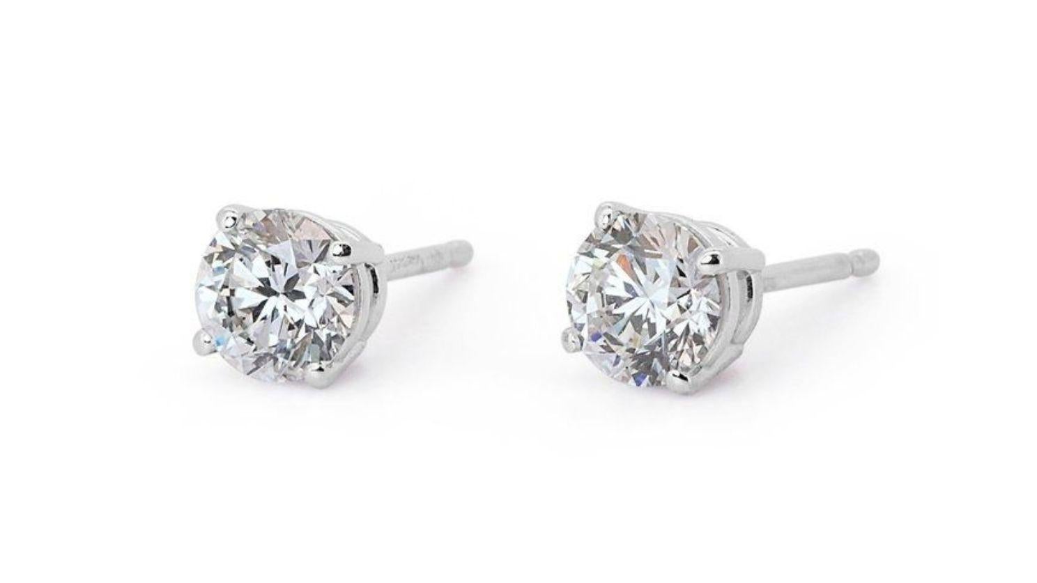 Introducing our exquisite Dazzling 1.41ct Round Brilliant Diamond Stud Earrings, crafted to captivate and enchant. Each earring boasts a stunning 1.41-carat round brilliant-cut diamond, meticulously selected for its exceptional quality and