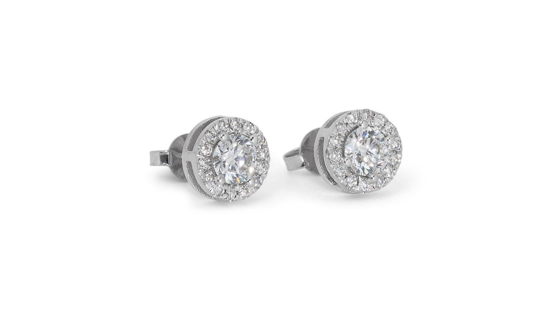 Dazzling 1.45ct Diamond Stud Earrings in 18k White Gold - GIA Certified

These stunning stud earrings in 18k white gold epitomize luxury and elegance, with a total carat weight of 1.20. Complementing the main stones, 28 additional round diamonds,