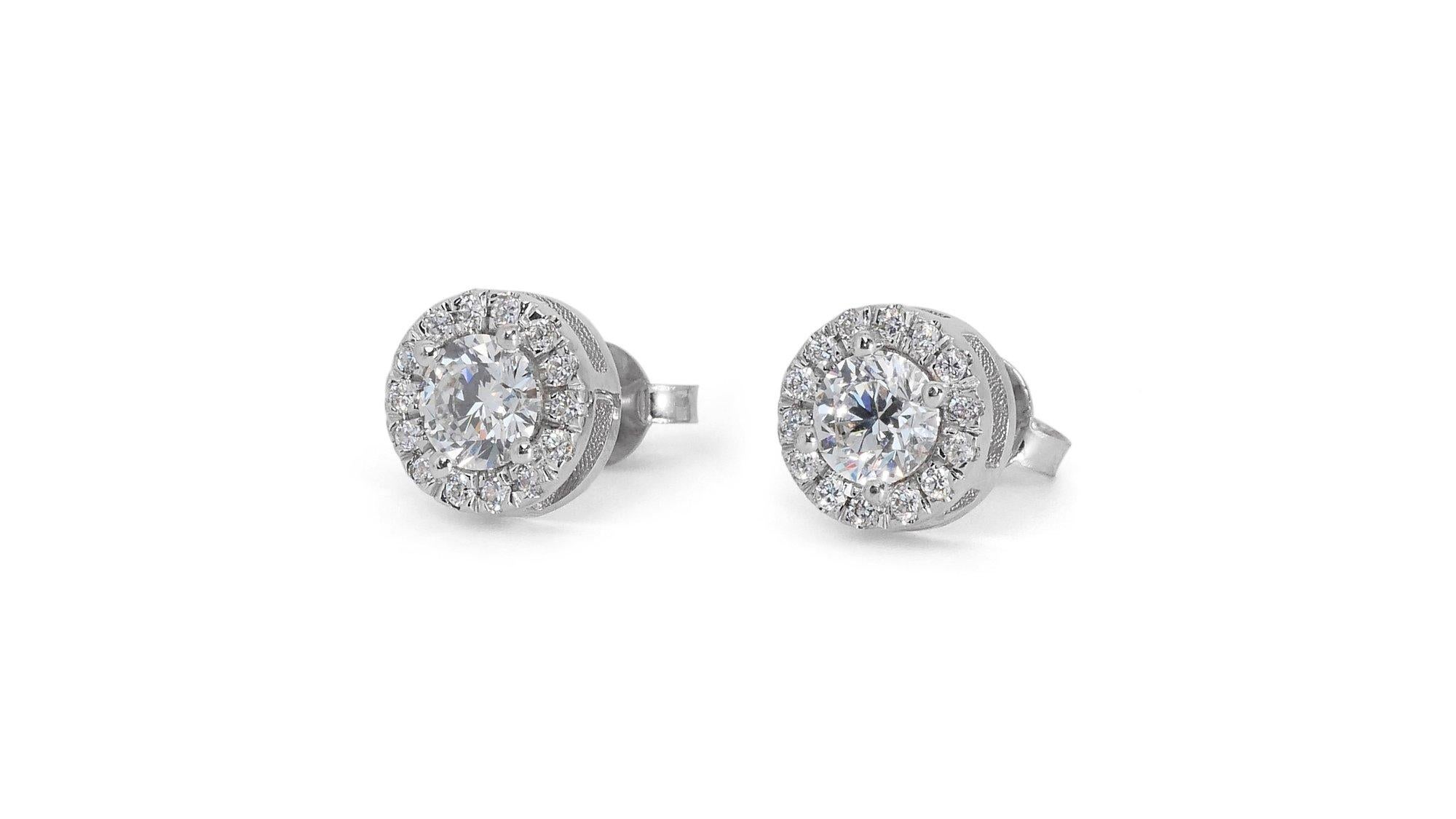 Dazzling 1.65ct Diamond Halo Stud Earrings in 18k White Gold - GIA Certified

Indulge in timeless elegance with these exquisite diamond halo stud earrings. Featuring a pair of mesmerizing round-cut diamonds, boasting an impressive 1.40 carats, these