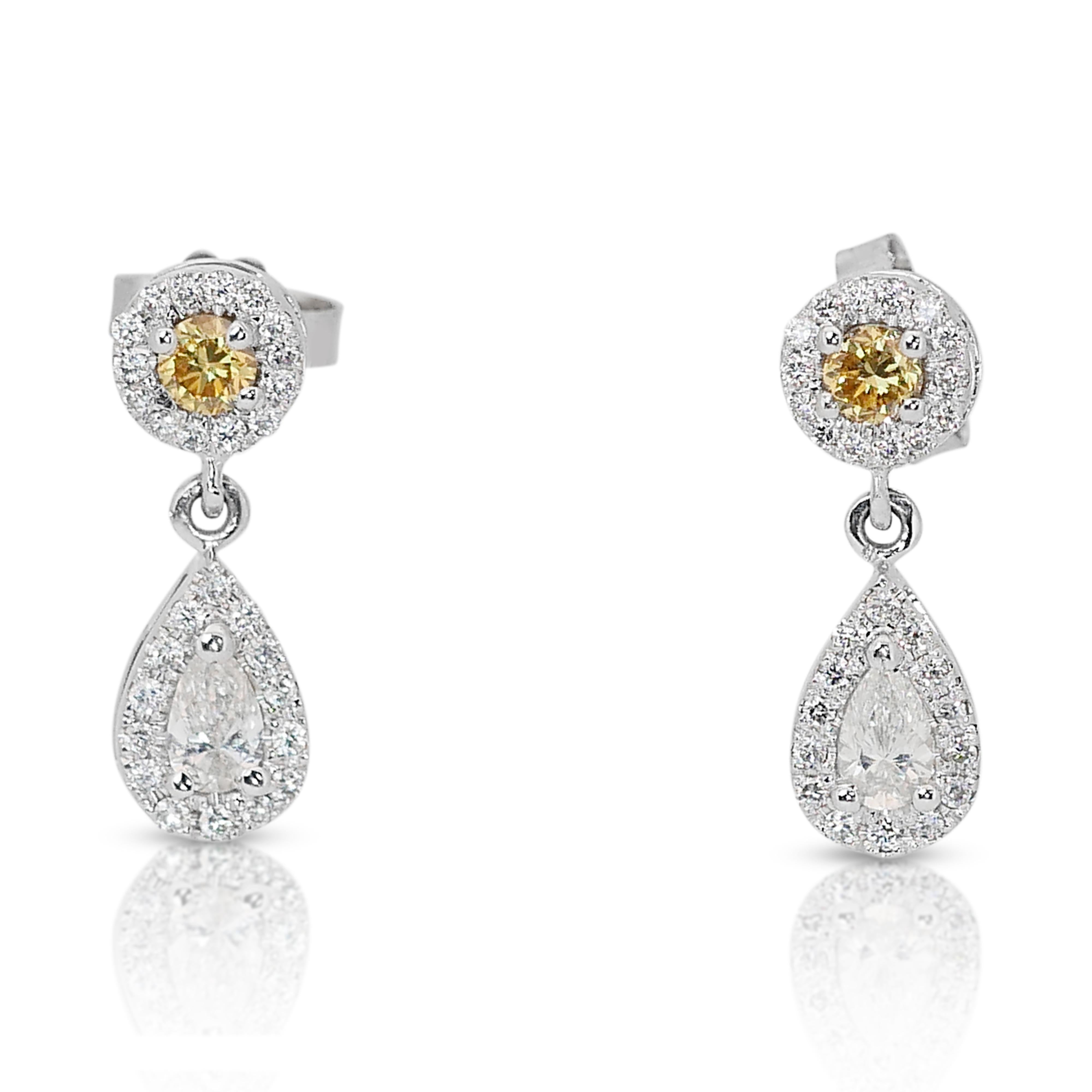 Dazzling 18k White Gold Natural Diamond Drop Earrings w/0.69 ct - IGI Certified

Indulge in the captivating brilliance of these 18k white gold drop earrings, boasting a stunning display of natural fancy vivid yellow diamonds. The center piece