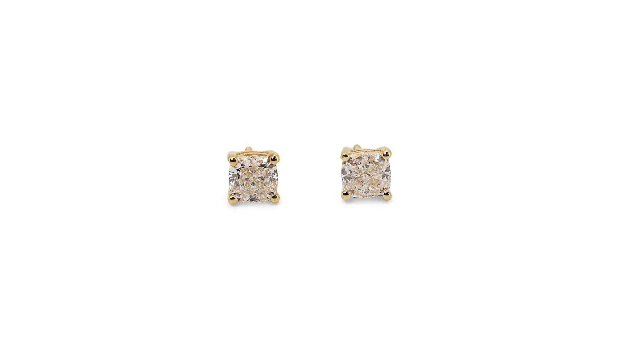 A gorgeous stud pair of earrings with dazzling 1.5-carat cushion shape diamonds. The jewelry is made of 18K Yellow Gold with a high-quality polish. It comes with an AIG certificate and a fancy jewelry box.

2 diamonds main stones total of 1.5
