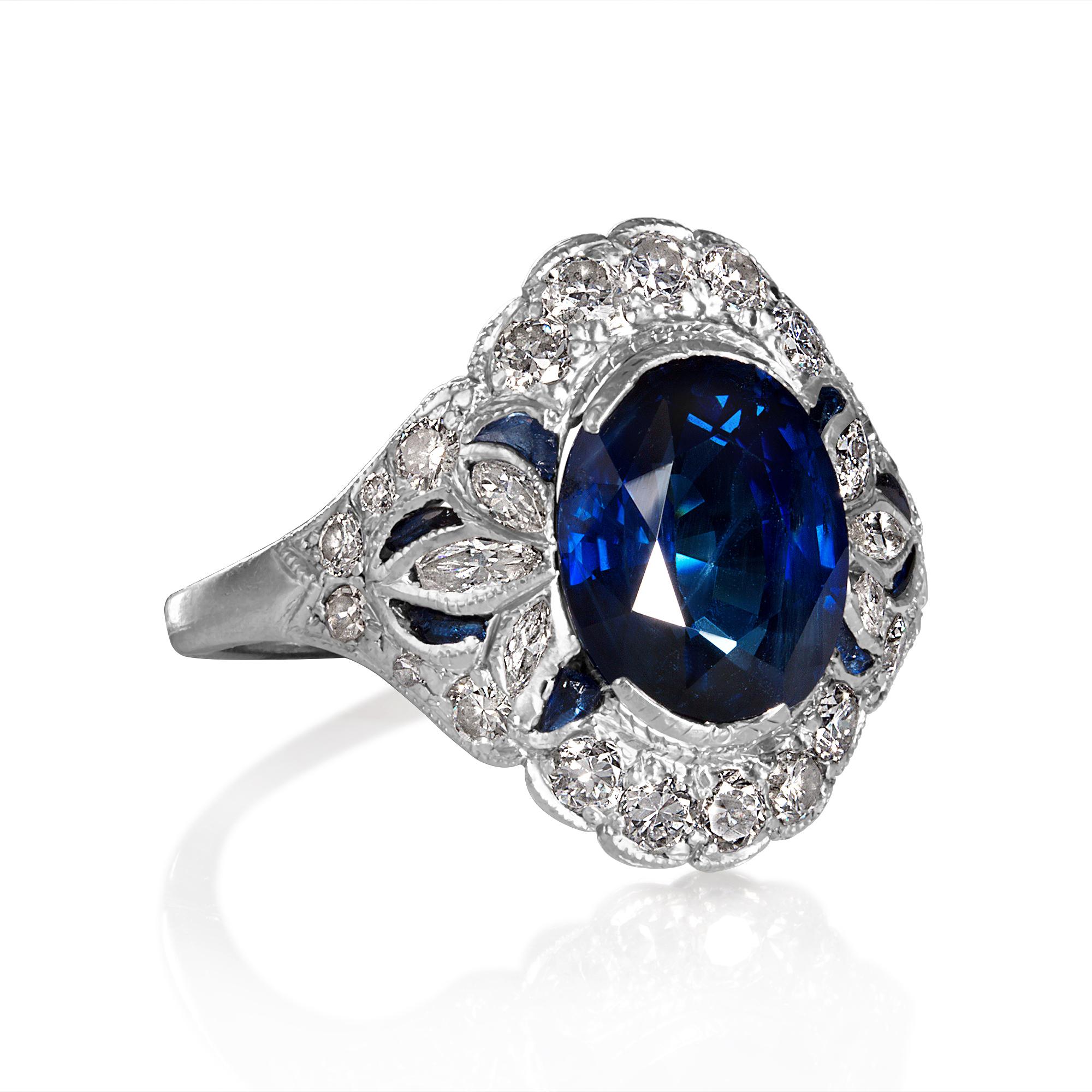 This Striking Authentic ART DECO , Circa 1917-1920, an exquisite handcrafted dinner ring featuring Ocean Blue Oval Cut Sapphire with European-Marquise cut, old cut diamonds and French cut blue sapphires in Platinum.

Shy 5.0carat (4.90ct) Natural