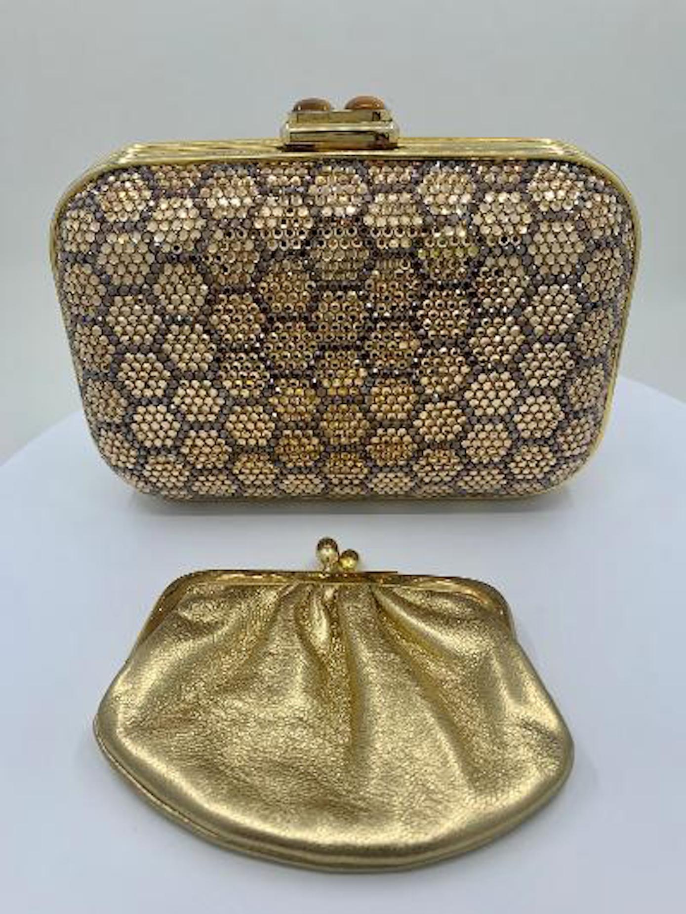 Meet a clutch with real icon status! This timeless and elegant hand made couture designer Judith Leiber rectangular shaped honeycomb pattern minaudiere evening bag or clutch has rounded corners and a gold toned metal frame covered in dazzling silver