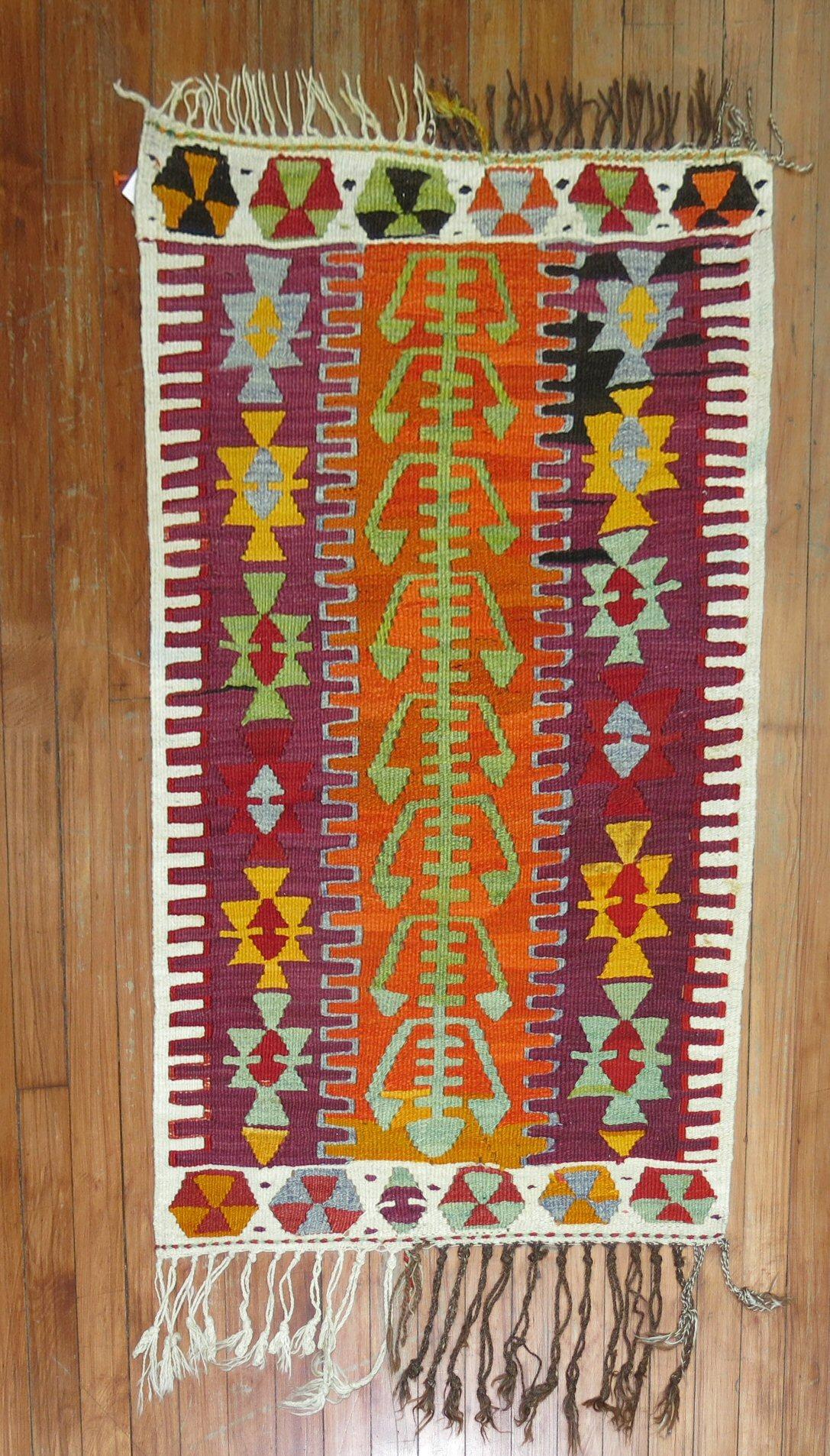 A scatter Turkish Kilim from the mid-20th century highlighted in purple & orange shades

Measures: 2'4'' x 3'7