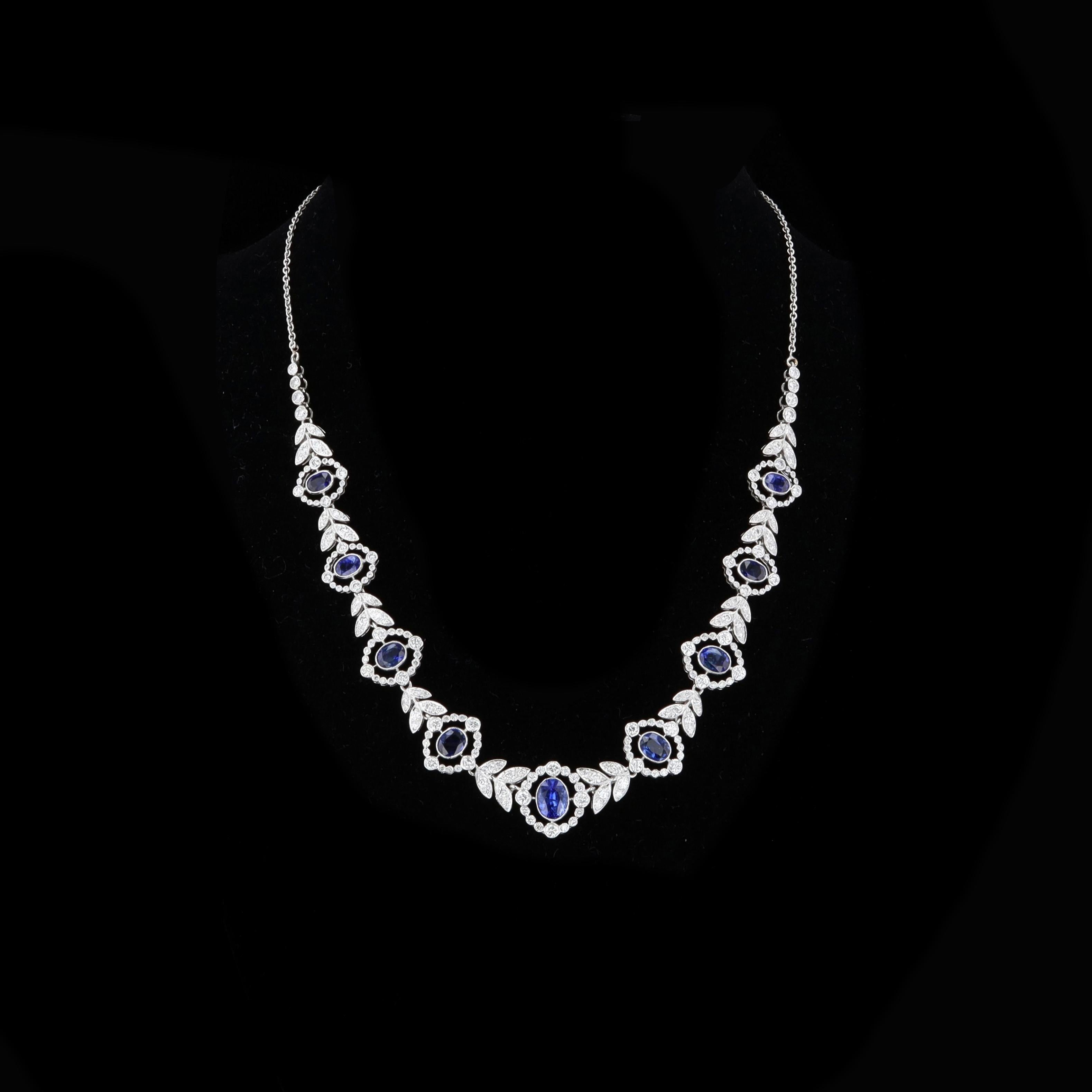 The classic combination of dazzling diamonds and deep hued sapphires make this show-stopping necklace a beautiful reminder that elegance is everything. The 18 karat white gold necklace weighs 19 grams and features nine oval cut sapphires weighing