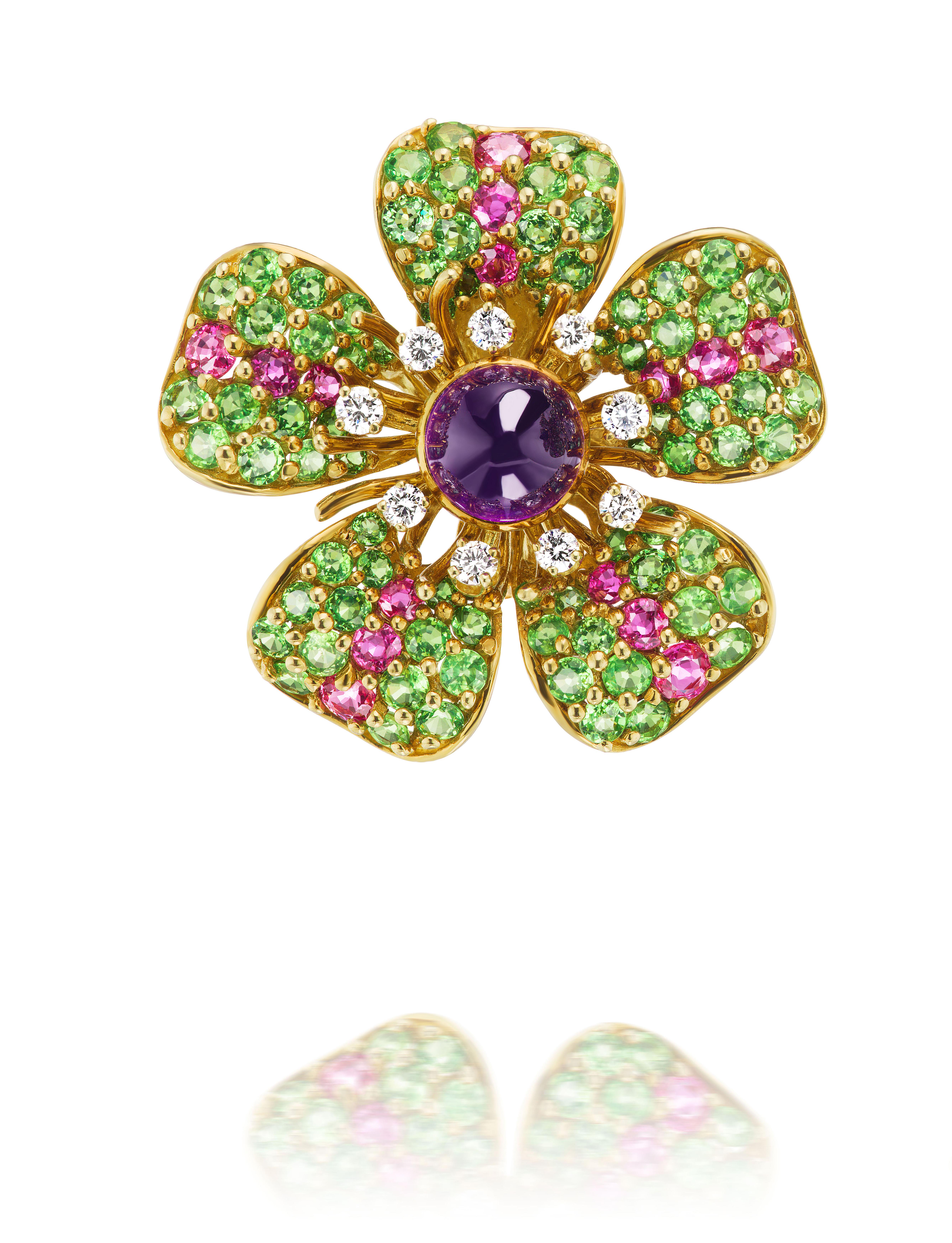 Wonderful crafted design by TIFFANY & CO circa 1993 consisting of impressive cabochon amethyst centers of approximately 5.20 carats accentuated by diamond stamen, and tsavorite and rhodolite petals in 18K gold. 

Stamped TIFFANY & CO 1993