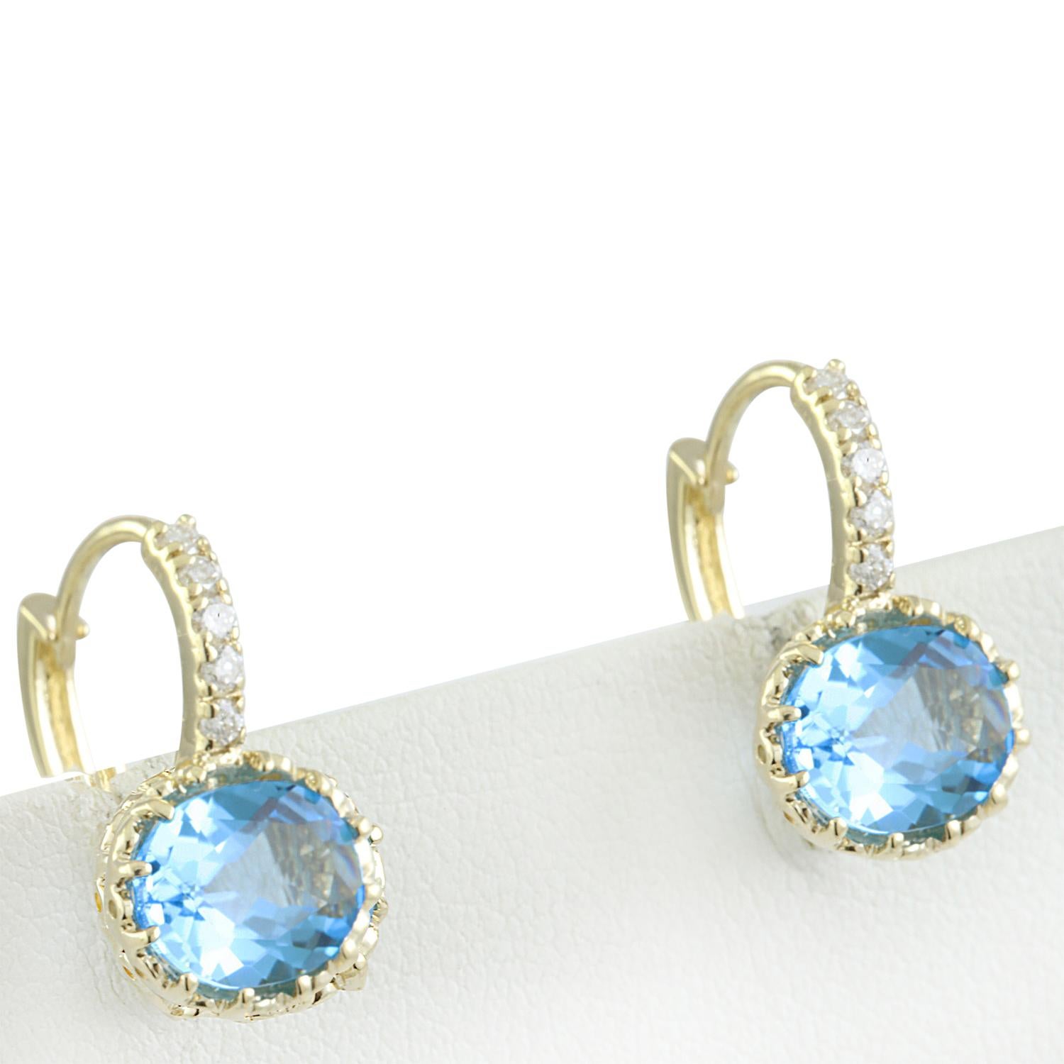 Introducing our elegant 14 Karat Solid Yellow Gold Diamond Earrings adorned with a stunning 4.40 Carat Natural Topaz, stamped for authenticity. Crafted with precision and style, these earrings are a true symbol of sophistication. Weighing 3.8 grams
