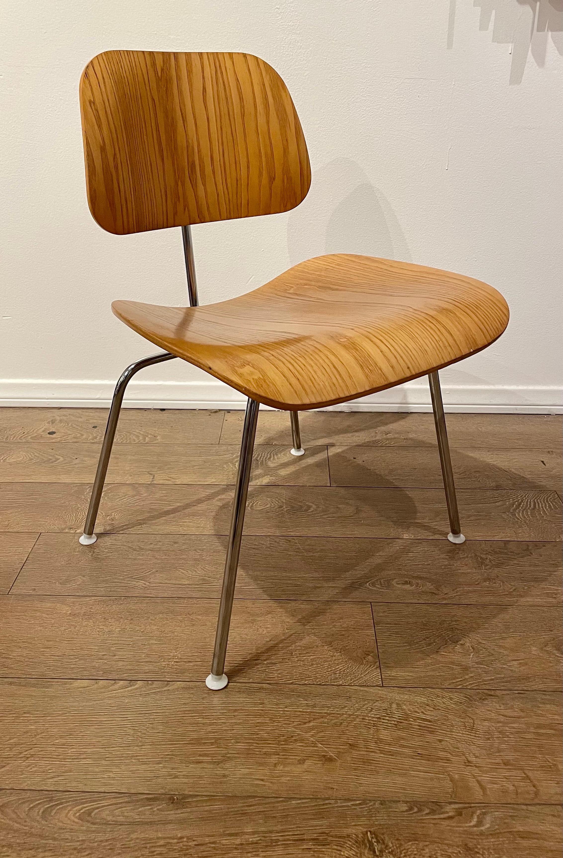 DCM chair designed by Eames for Herman Miller nice condition light wear in light walnut, with chrome base. Produced in 2006.
