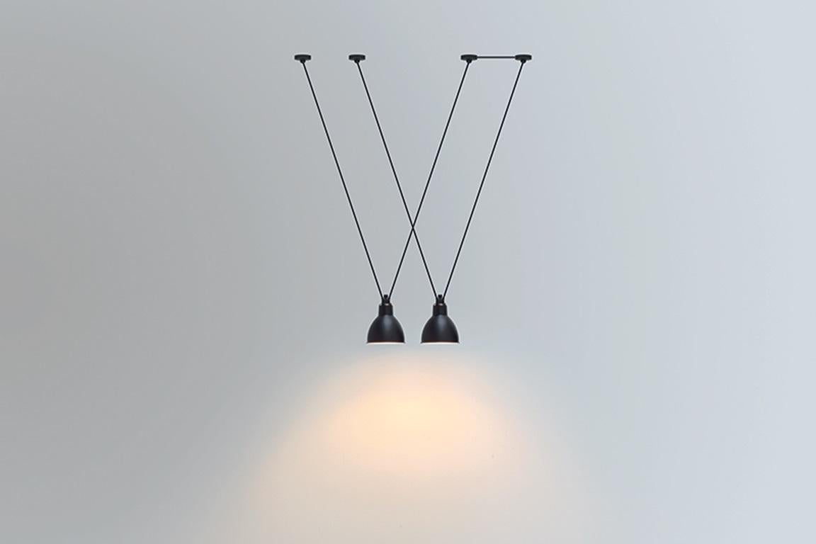 DCW Editions Les Acrobates N°323 AC1 AC2 Large Round Pendant Lamp in Black Steel Arm and Frosted Glass Shade by Bernard-Albin Gras
 
Les Acrobates de GRAS are adept at doing tricks high in the air, way above the ground. The high wire flyers (Nº323,