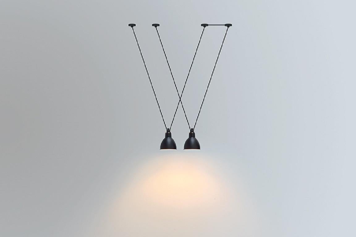 DCW Editions Les Acrobates N°323 AC1 AC2 Large Round Pendant Lamp in Black Steel Arm and Red Shade by Bernard-Albin Gras
 
 Les Acrobates de GRAS are adept at doing tricks high in the air, way above the ground. The high wire flyers (Nº323, Nº324,