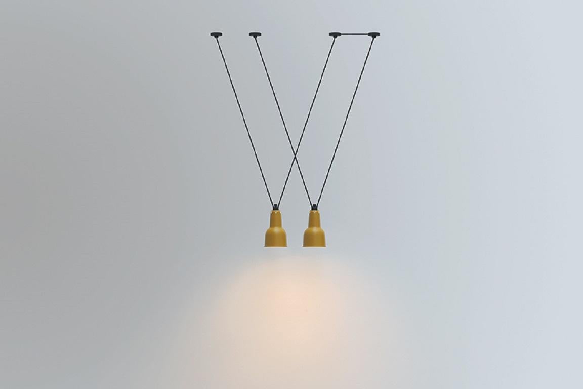 DCW Editions Les Acrobates N°323 AC1 AC2(L) Oculist Pendant Lamp in Black Steel Arm and Yellow Shade by Bernard-Albin Gras
 
Les Acrobates de GRAS are adept at doing tricks high in the air, way above the ground. The high wire flyers (Nº323, Nº324,