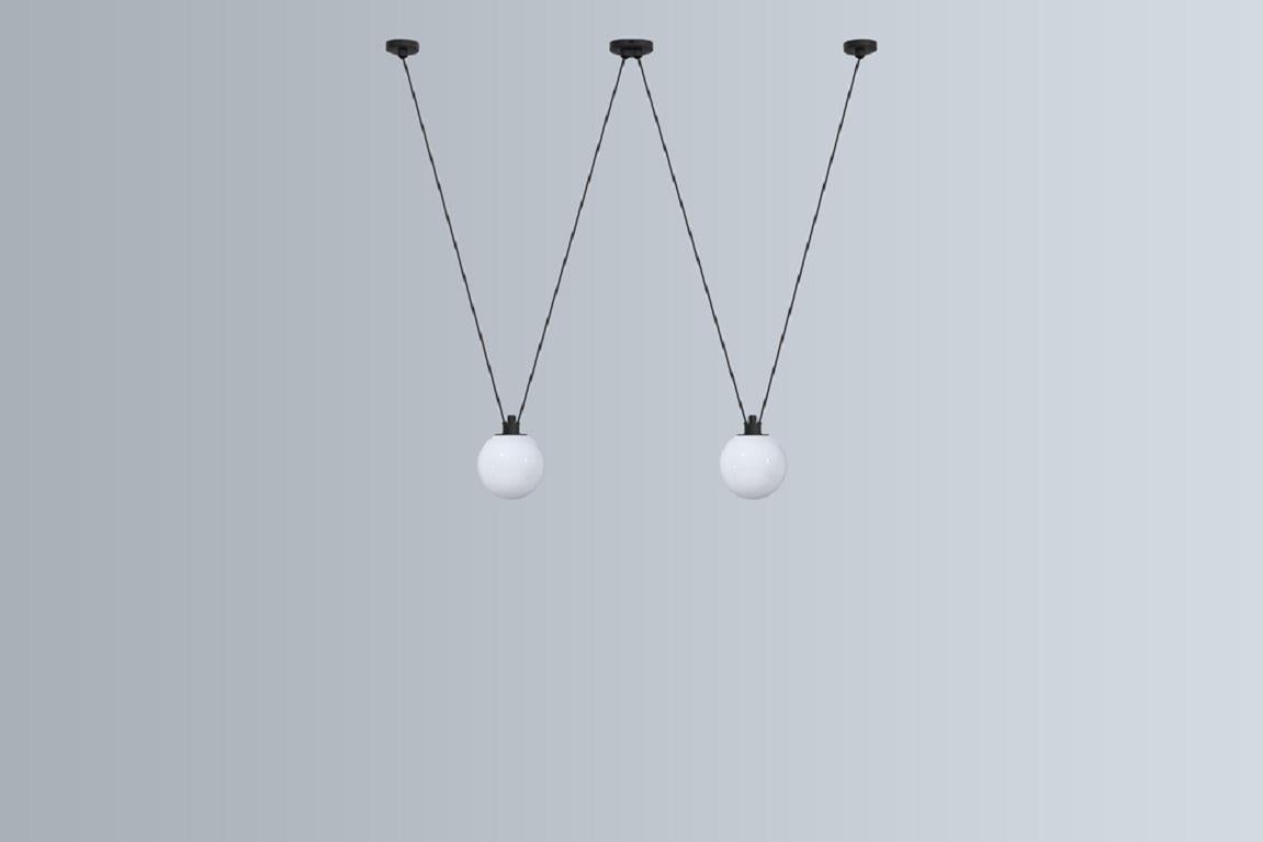 DCW Editions Les Acrobates N°324 Pendant Lamp in Black Steel Arm and Large Glassball by Bernard-Albin Gras
 
 Les Acrobates de GRAS are adept at doing tricks high in the air, way above the ground. The high wire flyers (Nº323, Nº324, Nº325, Nº326,