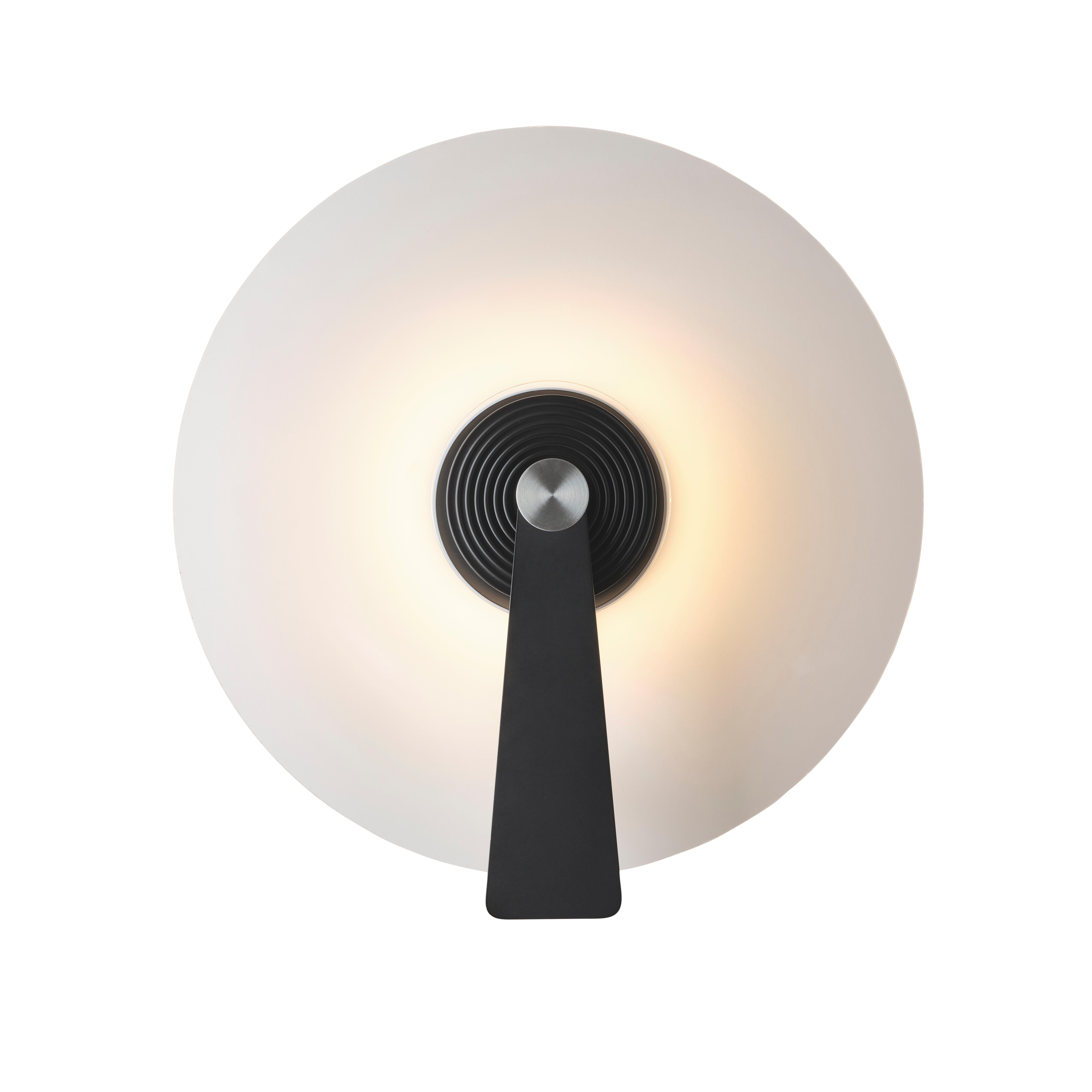 DCW Editions Pan Wall Lamp in Black Aluminium by Simon Schmitz
 
 Across the globe, light evolves over time.
 From the soft and reassuring light of the candle to the raw LED brightness of the refrigerator light, centuries have passed.
 Are we at the