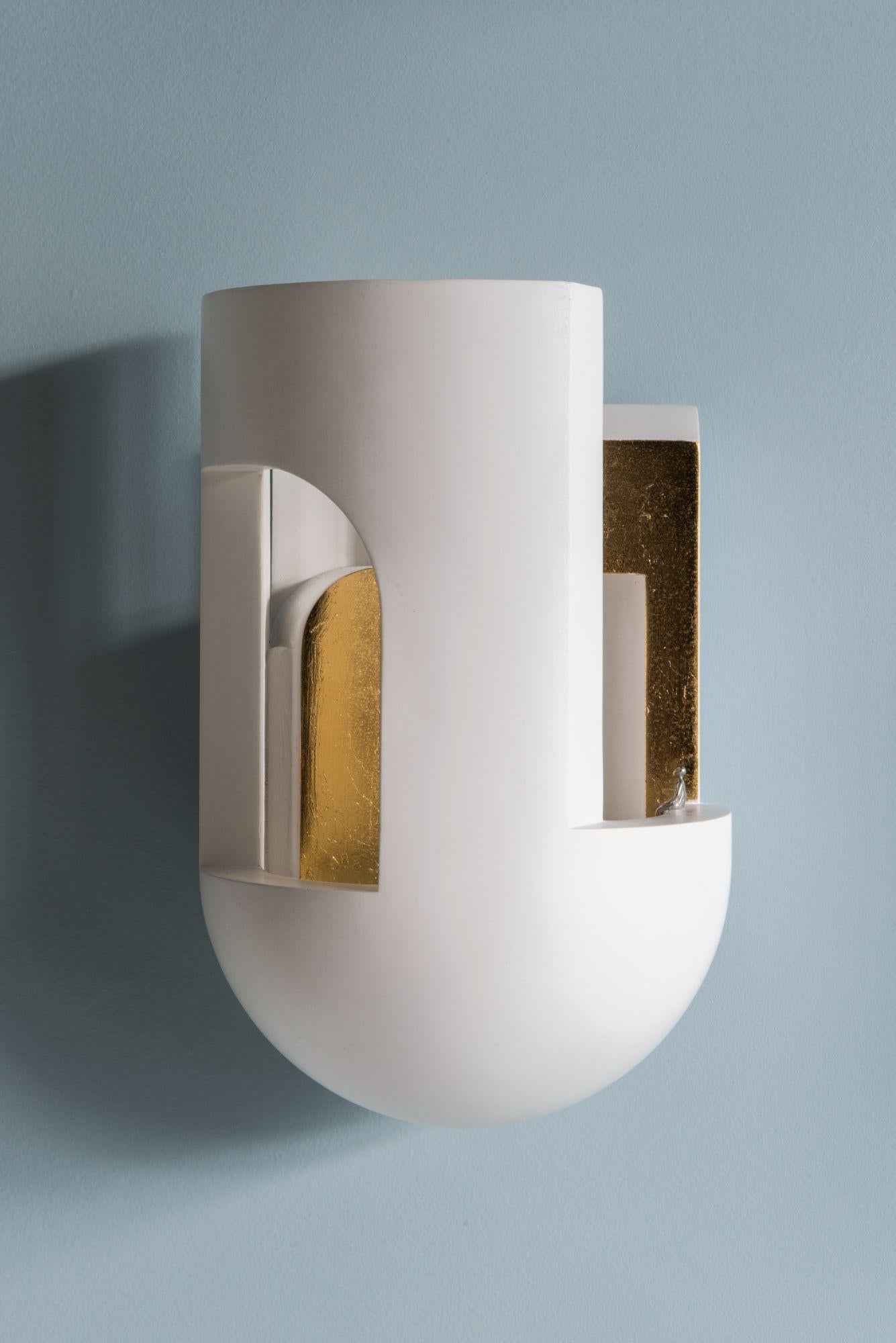 DCW Editions Soul Story 3 Wall Lamp in White and Gold Leaf by Charles Kalpakian
 
 Plaster lamp intended as wall lamps and designed to be scrutinised as if entering a dark alley at dusk and suddenly being pierced with a surreal ray of light.
 A