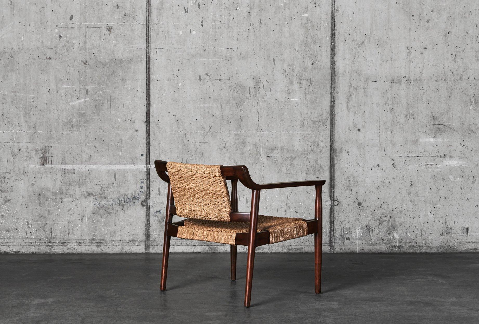 DD Abaca rope chair is designed by Dusty Deco. The armchair has a frame and legs consisting of dark stained, cultivated mahogany. In addition to staining, the chair's frame and legs have also been waxed to achieve a matte finish. Abaca is a natural