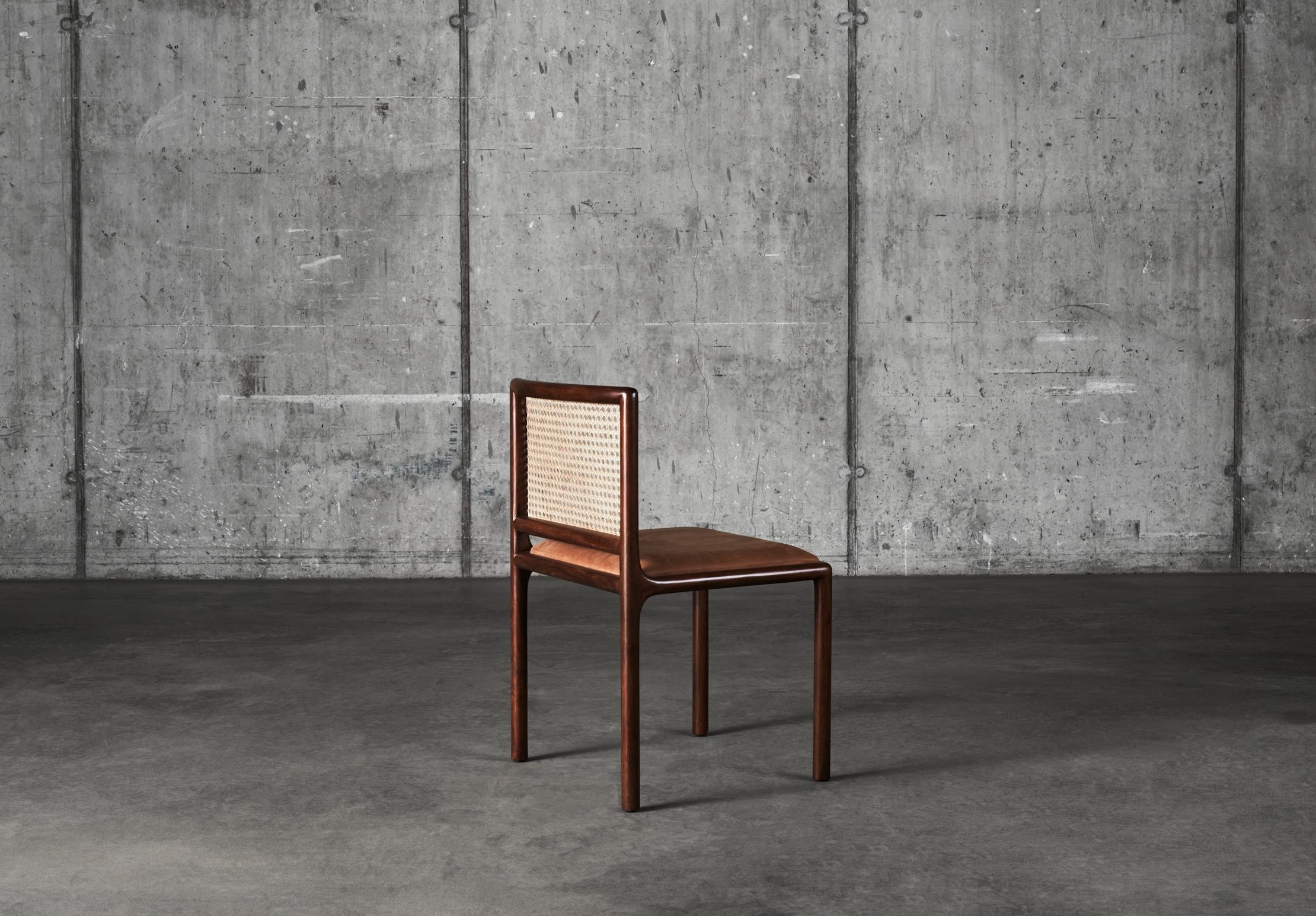 A clean timeless look made in cultivated mahogany and rattan. The seat is upholstered in leather from Danish Sörensen Leather. Dunes cognac is an exclusive Aniline leather with a natural, rustic look and a sublime, almost velvety tactile feel.