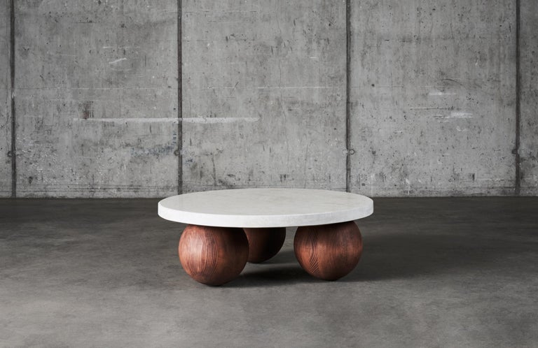 We love this table, the low look, the wooden orbs and the heavy stone. The wooden orbs are made out of solid beech wood that has been stained and oiled, the stone is a granit called Vraca with a nice warm beige tone. 

Please note that granite is a