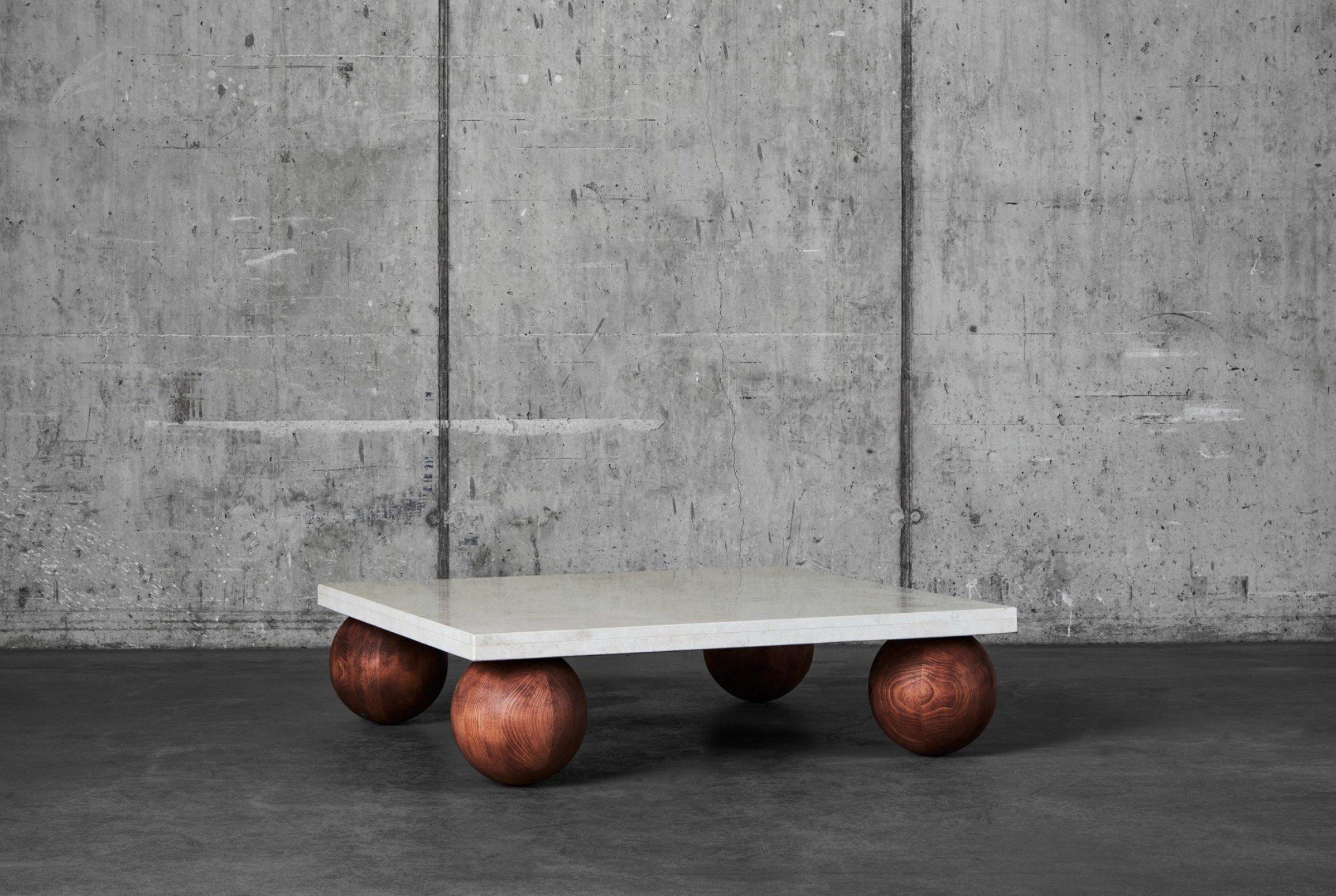We love this table, the low look, the wooden orbs and the heavy stone. The wooden orbs are made out of solid beech wood that has been stained and oiled, the stone is a granit called Vraca with a nice warm beige tone.
Measurements: 120 x 120 x 30 cm