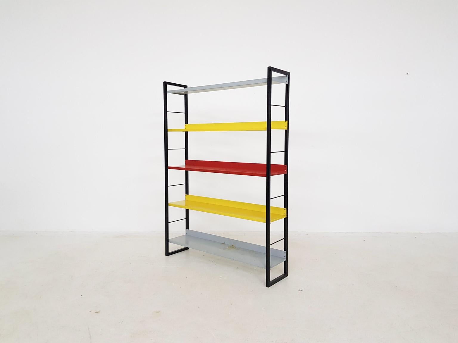 Iconic Dutch design. The metal coloured bookcase or shelves by D. Dekker for Tomado. Dutch mid-century design at its finest, designed and made in the 1950's. Tomado was a Dutch furniture producer mainly famous for their coloured wall shelves and