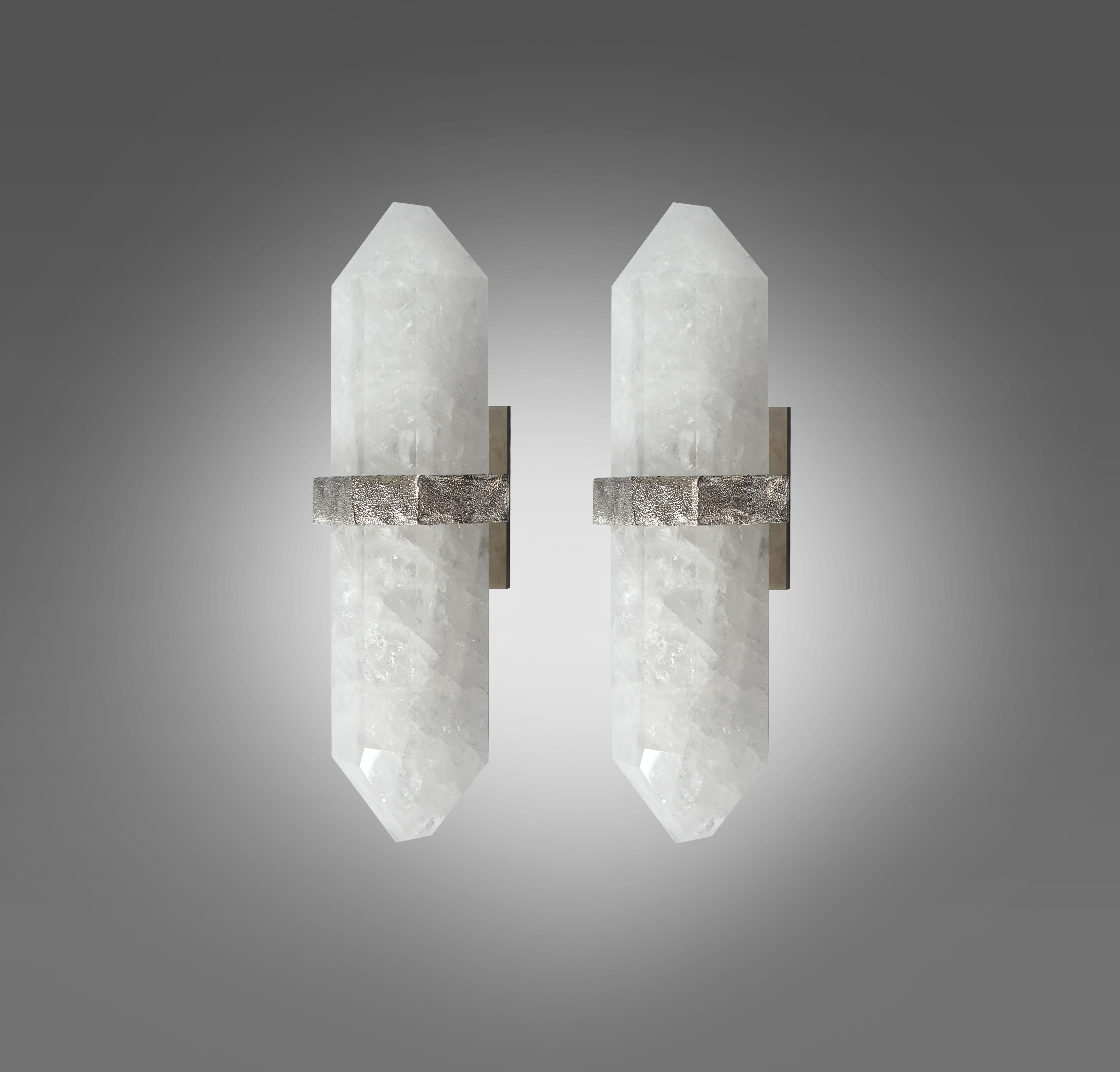 A fine carved diamond form rock crystal quartz wall sconces, mount with rich texture of cast nickel plating decoration, created by Phoenix gallery NYC. Custom size available.
Each sconce installed two sockets, and will including two LED light bulbs