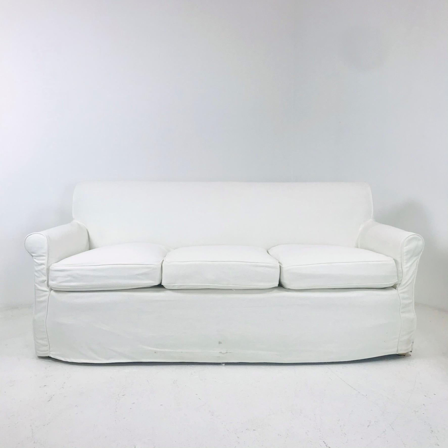 Remarkable 68” three pillow sofas, manufactured by De Angelis & chosen by Billy Baldwin in 1960 for Centre Island, Oyster Bay residence. The sofas are covered in a Chenille fabric, 69” W x 34” D x 32” H. Includes custom white slipcovers, and