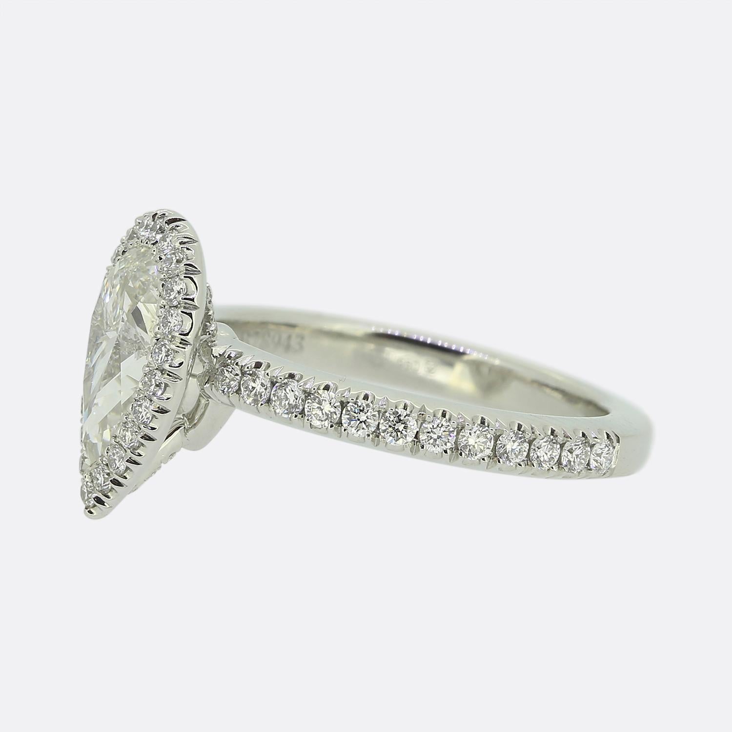 Here we have an outstanding diamond engagement ring from the world renowned diamond group, De Beers. This platinum piece showcases a delightful 0.88 carat pear cut diamond which sits proud at the centre of the face and is surrounded by a single row