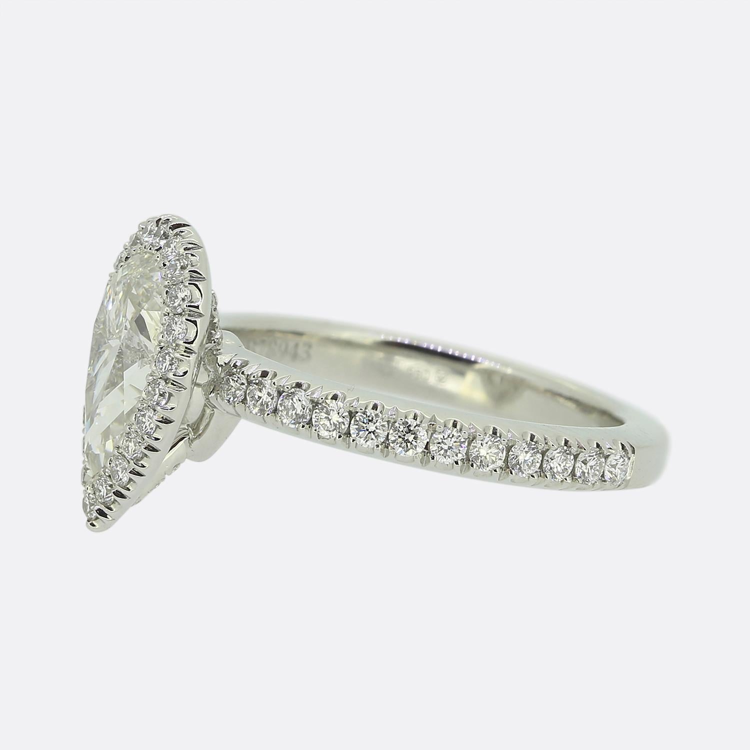Here we have an outstanding diamond engagement ring from the world renowned diamond group, De Beers. This platinum piece showcases a delightful 0.88 carat pear cut diamond which sits proud at the centre of the face and is surrounded by a single row