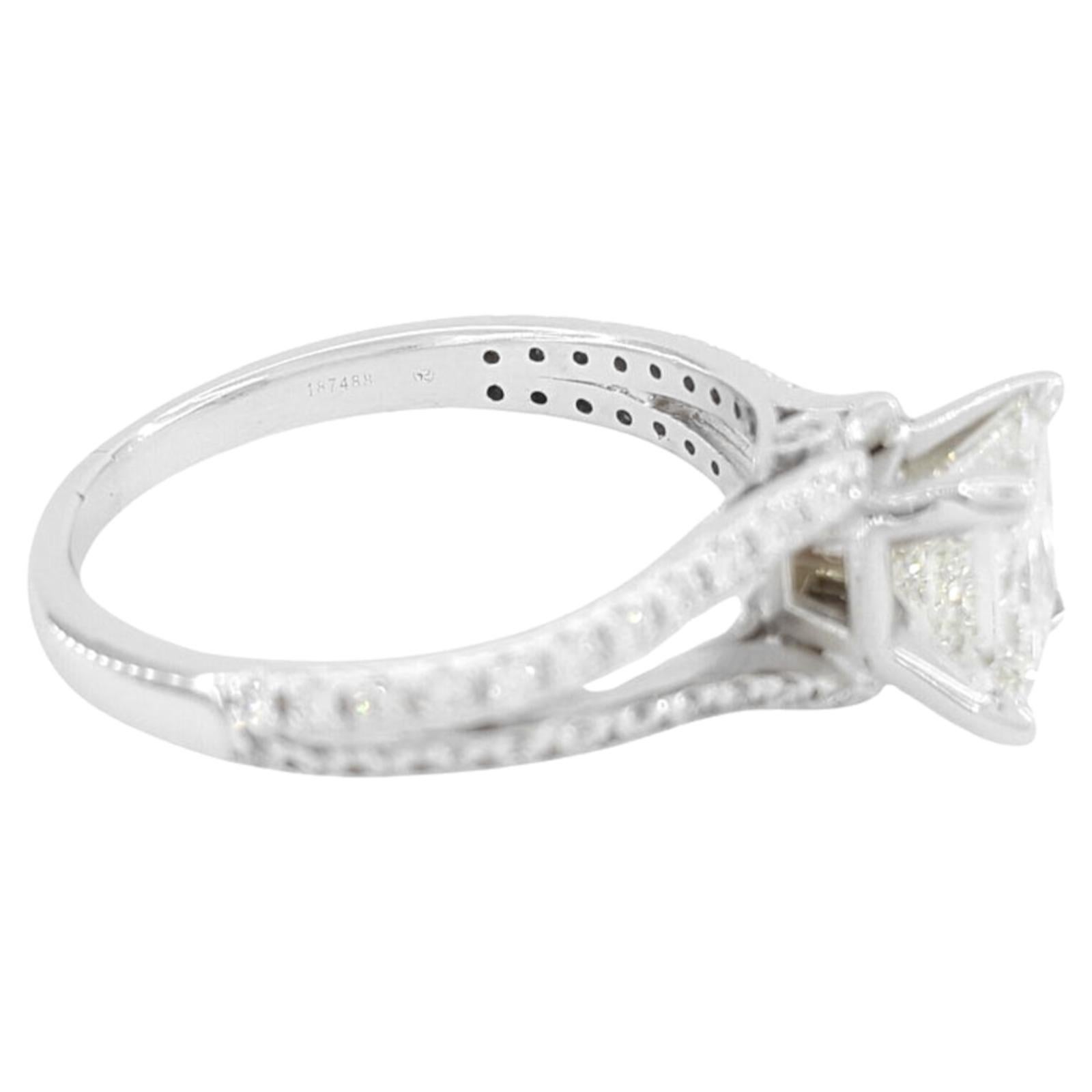 1.59 ct Total Weight 14k White Gold Princess & Round Brilliant Cut Diamond Split Shank Engagement Ring features a center stone that is a natural princess brilliant cut diamond weighing 1.35 ct. This diamond has a J color rating and VS1 clarity. It