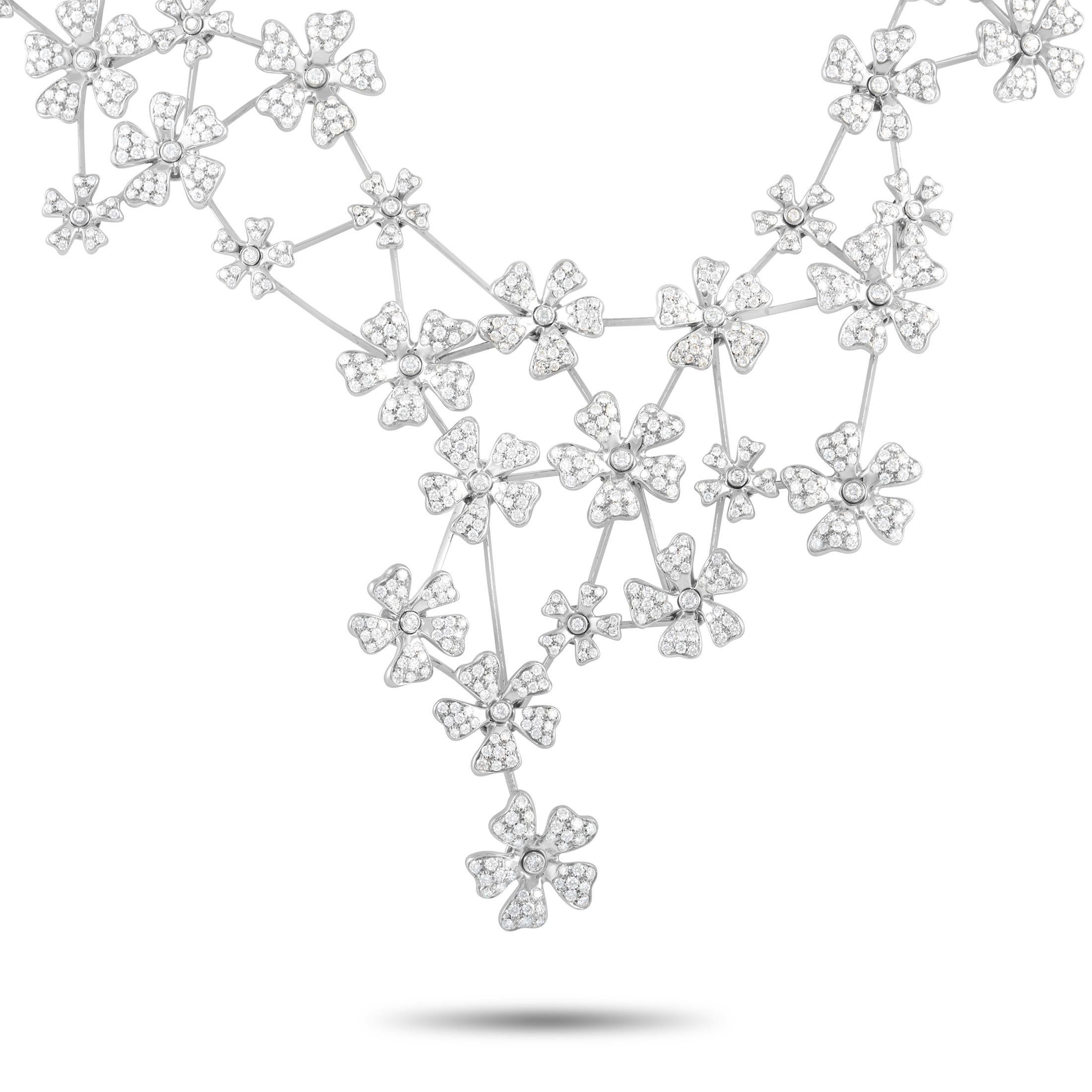 This gorgeous De Beers necklace is a spectacular statement piece. It is crafted from 18K white gold that features flowers throughout the necklace that are set with a total of 21.50 carats of round diamonds. The necklace measures 17.5 inches in