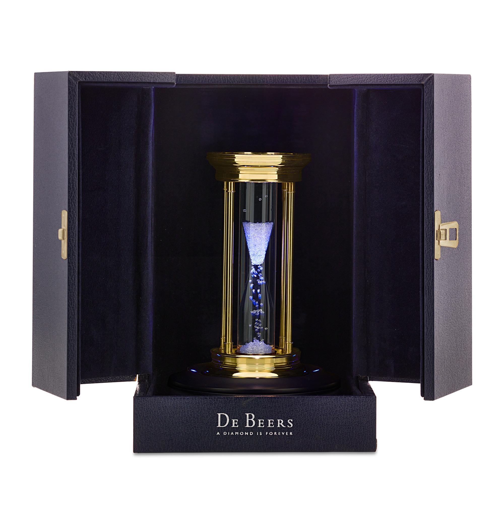 This Limited Edition Millennium 2000 Diamond Brass Hourglass Timer by De Beers features an hourglass filled with over 2,000 natural rough diamonds, weighing approximately 36 carats and suspended in a silicone fluid. Instead of traditional sand,