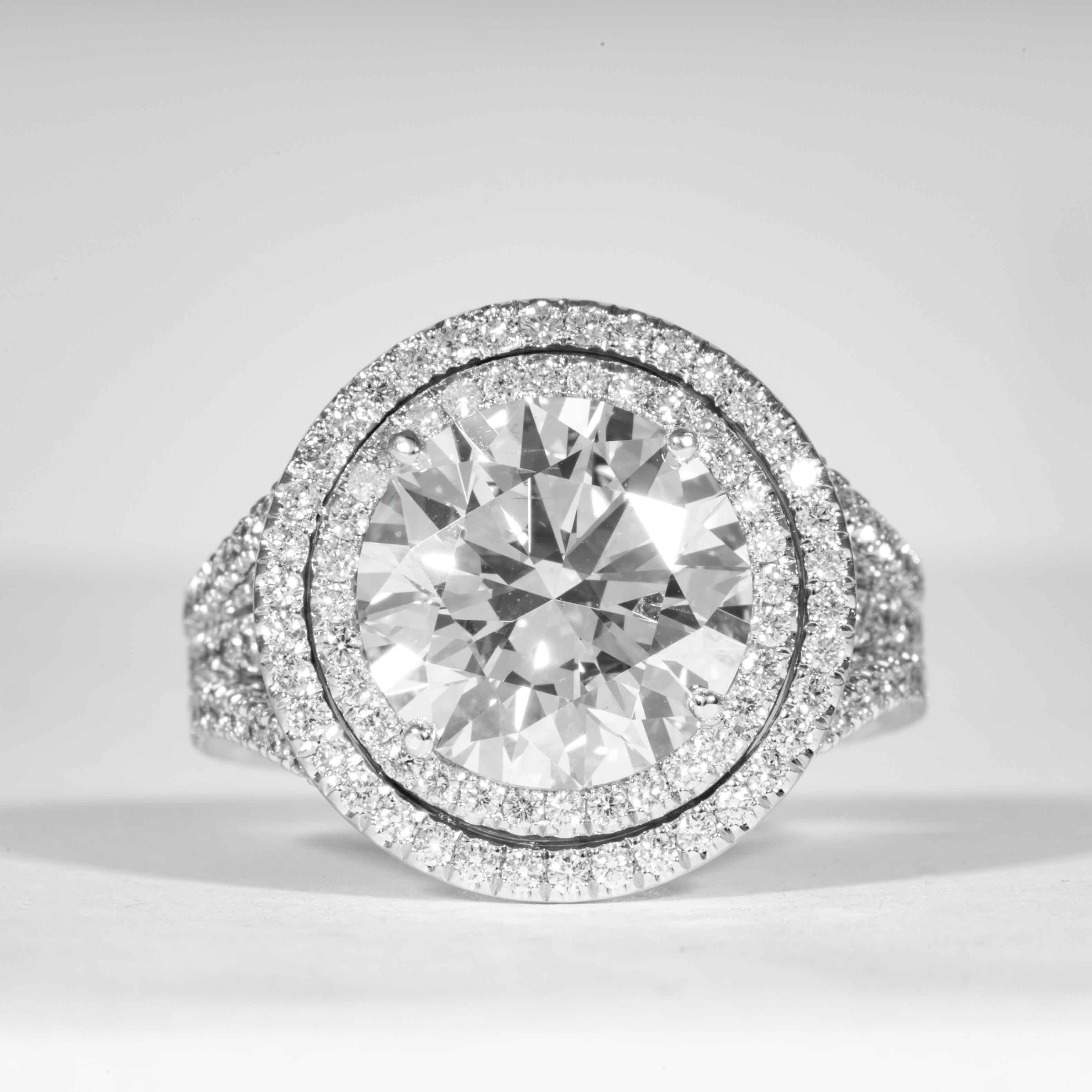 This stunning diamond ring is offered by Shreve, Crump & Low.  This 5.01 carat GIA Certified H SI1 round brilliant cut diamond measuring 10.98 - 11.04 x 6.74 mm is custom set in a handcrafted De Beers platinum double halo ring. The 5.01 carat round