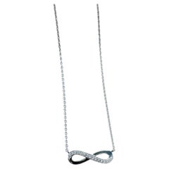 Collection Infinity de De Beers : collier avec diamant en forme de symbole de l'infini
