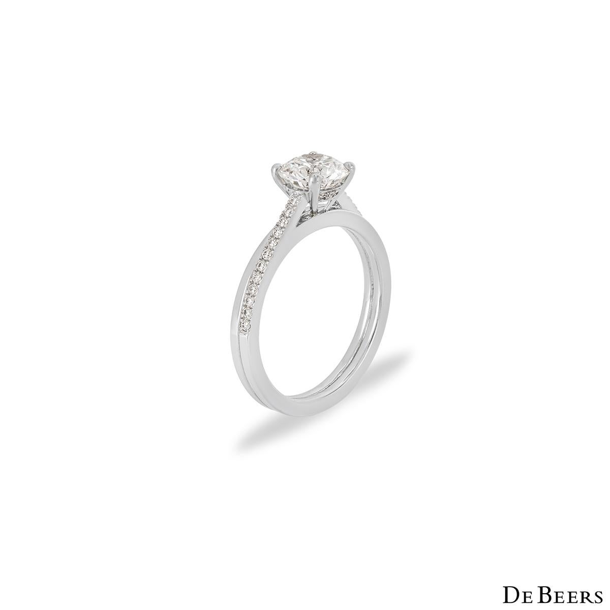 A captivating platinum diamond ring from The Promise collection by De Beers. The ring is set to the centre with a round brilliant cut diamond weighing 1.14ct, F colour and IF clarity (Internally Flawless). The shoulders of the ring are made up of a