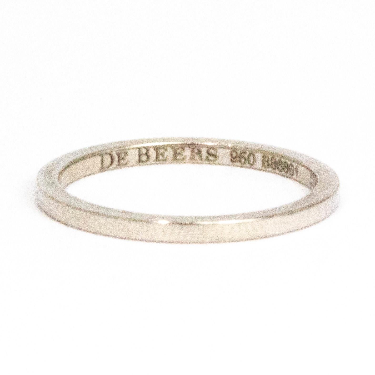 This gorgeously simple band is created by the wonderful jeweller De Beers. The band is modelled in platinum and has such a simple yet beautiful design. The inner band has the makers signature and code engraved.

Ring Size: J 1/2 or 5
Band Width: