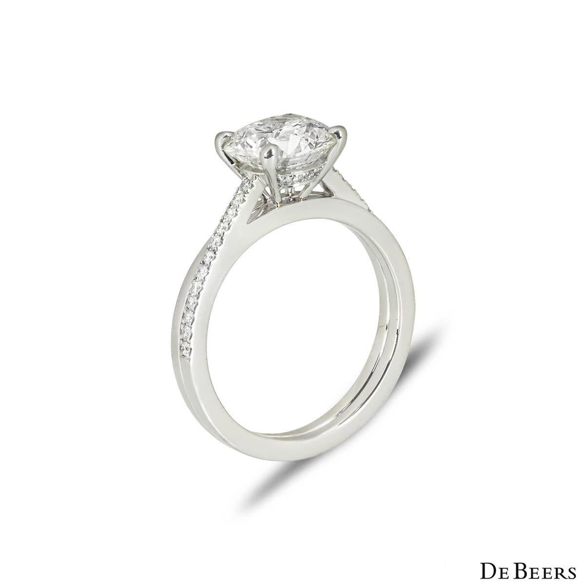 A spectacular platinum diamond engagement ring by De Beers from The Promise collection. Set to the centre in a four-prong mount is a round brilliant cut diamond weighing 2.05ct, I colour and SI2 clarity. The diamond scores an excellent rating in all
