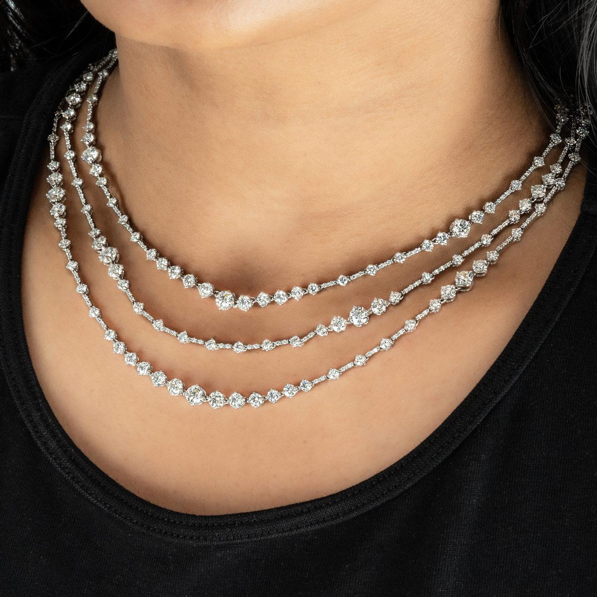 A luxurious white gold De Beers diamond necklace from the Arpeggia collection. The necklace comprises 3 rows, set with a total of 469 round brilliant cut diamonds. Each row features a combination of single round brilliant cut diamonds in prong