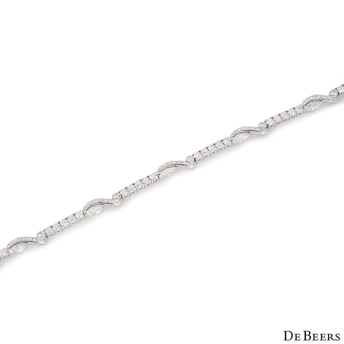 An elegant 18k white gold diamond bracelet by De Beers from the Adonis Rose collection B1021570018. The one line bracelet is set with 5 marquise cut and  86 round brilliant cut diamonds with an approximate weight of 5.35ct, E-F colour and VS