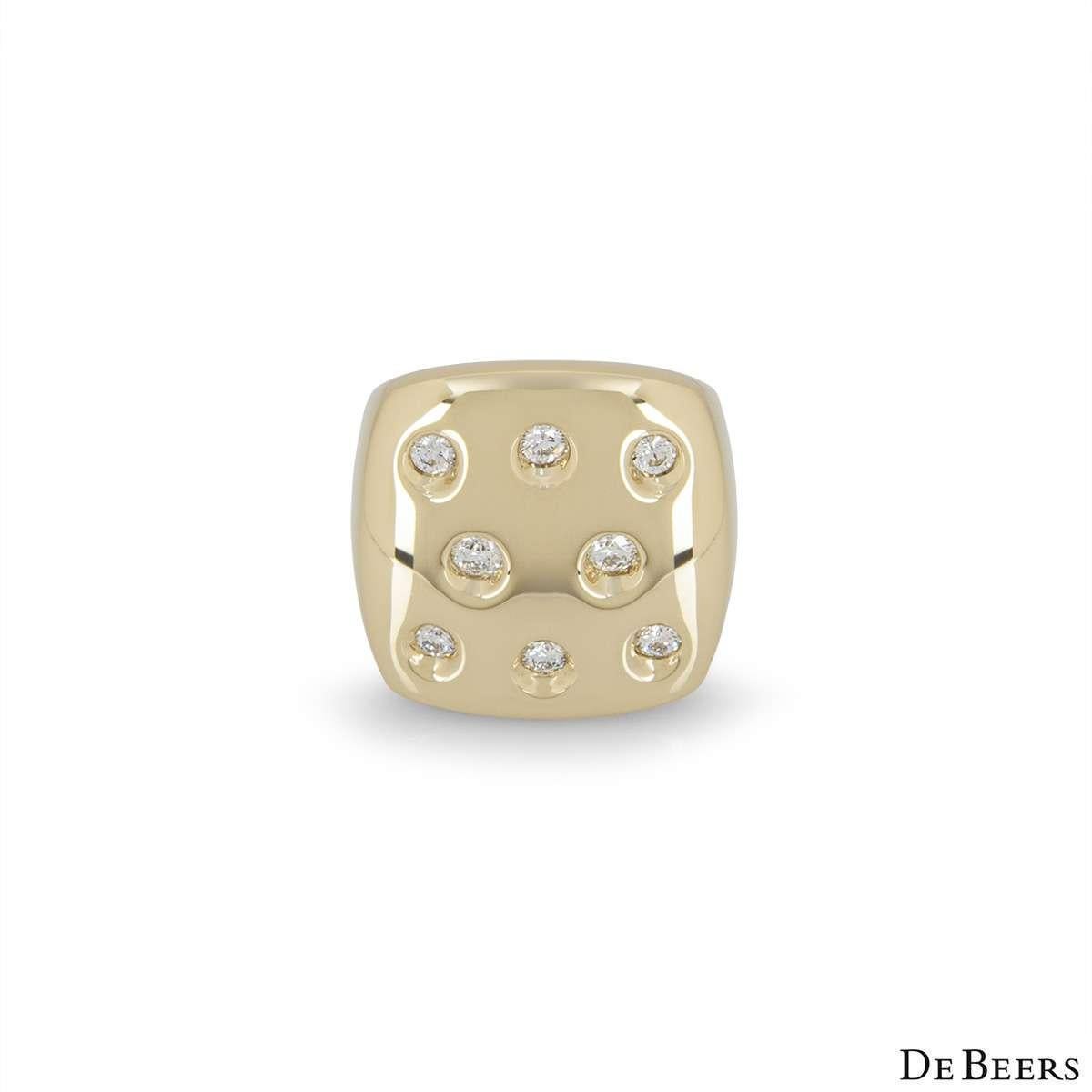 An 18k yellow gold dress ring by De Beers. The front of the ring is square in shape and is set with 8 round brilliant cut diamonds totalling approximately 0.56ct. The ring measures 2.2cm in width and is a size UK M - EU 52 - US 38, with a gross