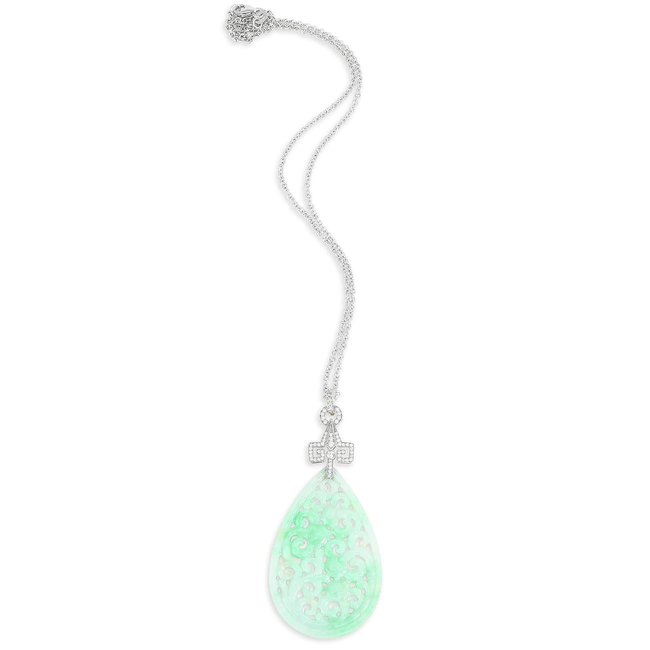 Flowers and vines thrive in this lush Jade pendant. The carved pear-shaped moss in snow jade dangles from a beautifully handcrafted diamond bale set in 18K white gold. Moss in snow is a classic jade pattern cherished for centuries. The deep green