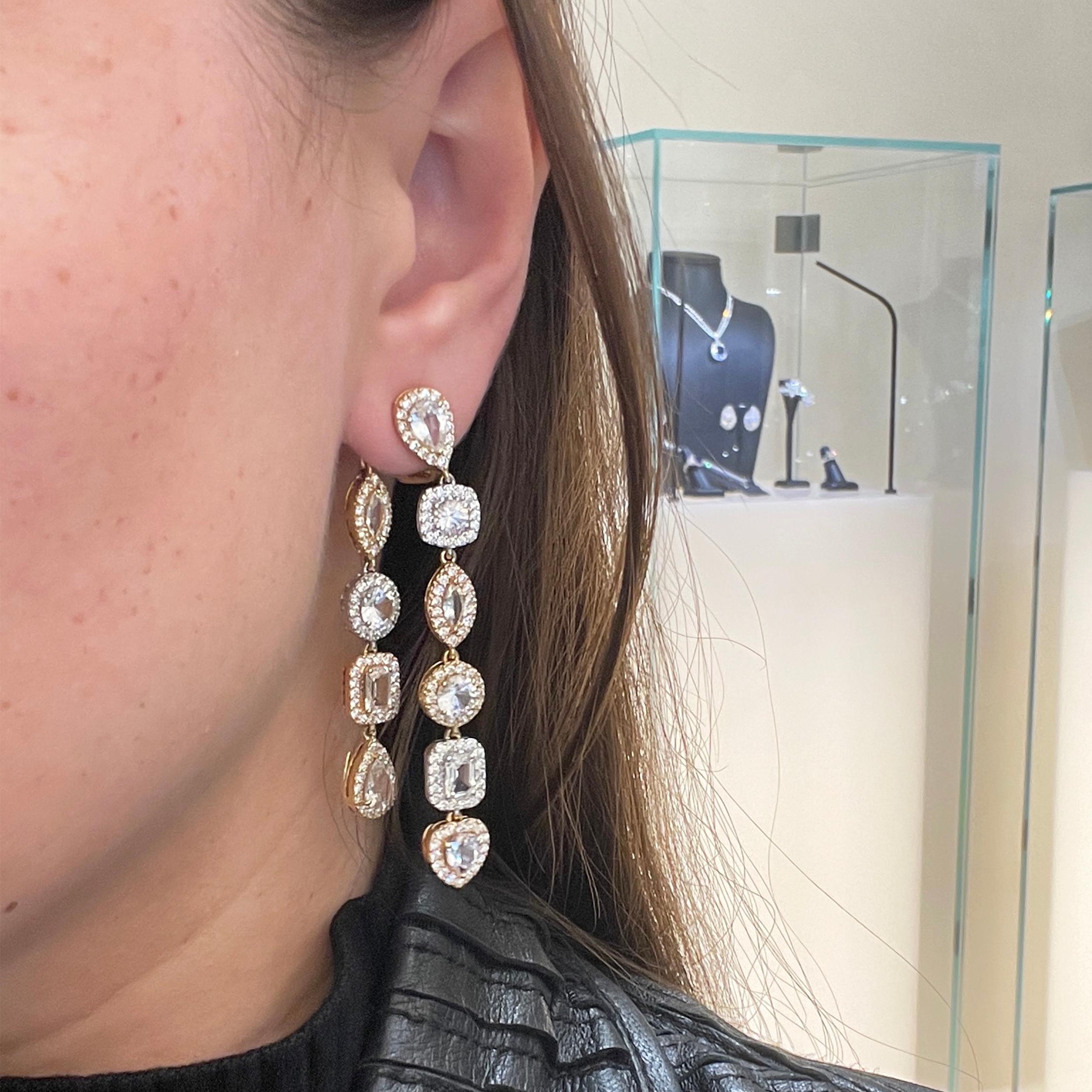 An array of fancy cut white sapphires dangle from your ears.  Each sapphire is surrounded by round brilliant diamonds and set in rose, white and yellow gold.

White Sapphires (11.65 ctw.)
Round Brilliant Diamonds (3.18 ctw.)
18K Rose Gold
18K White