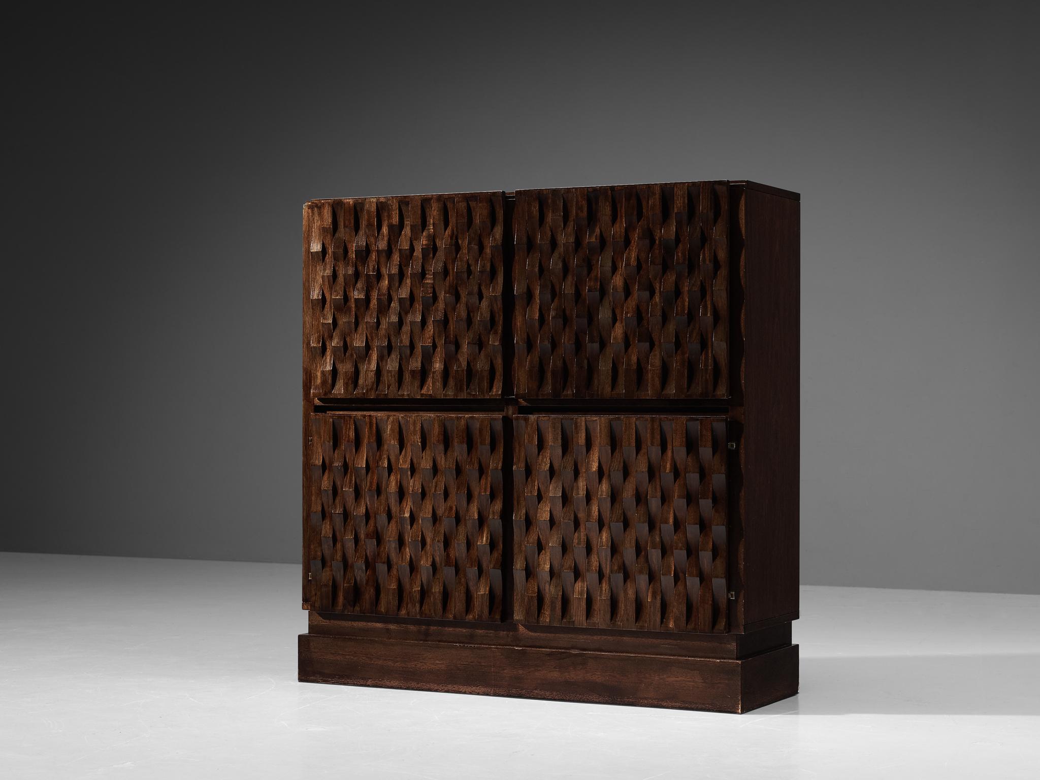 De Coene, highboard or drybar, oak, laminated wood, Belgium, 1970s.

This very evocative drybar by De Coene features a clear rhythm and flow established by means of a well thought through lay out that is very well-balanced. The carved door panels